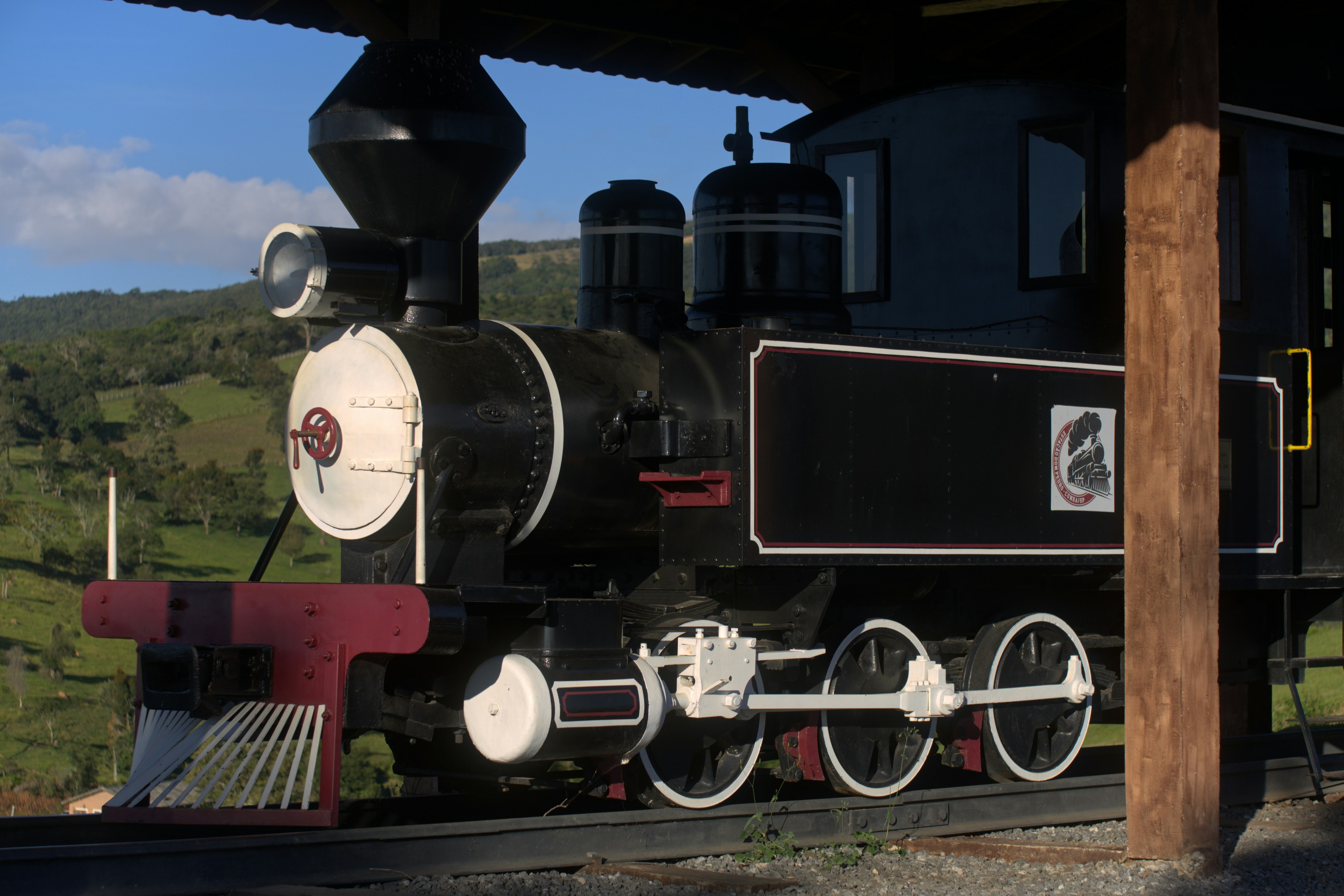 A vintage black steam train sits on tracks.