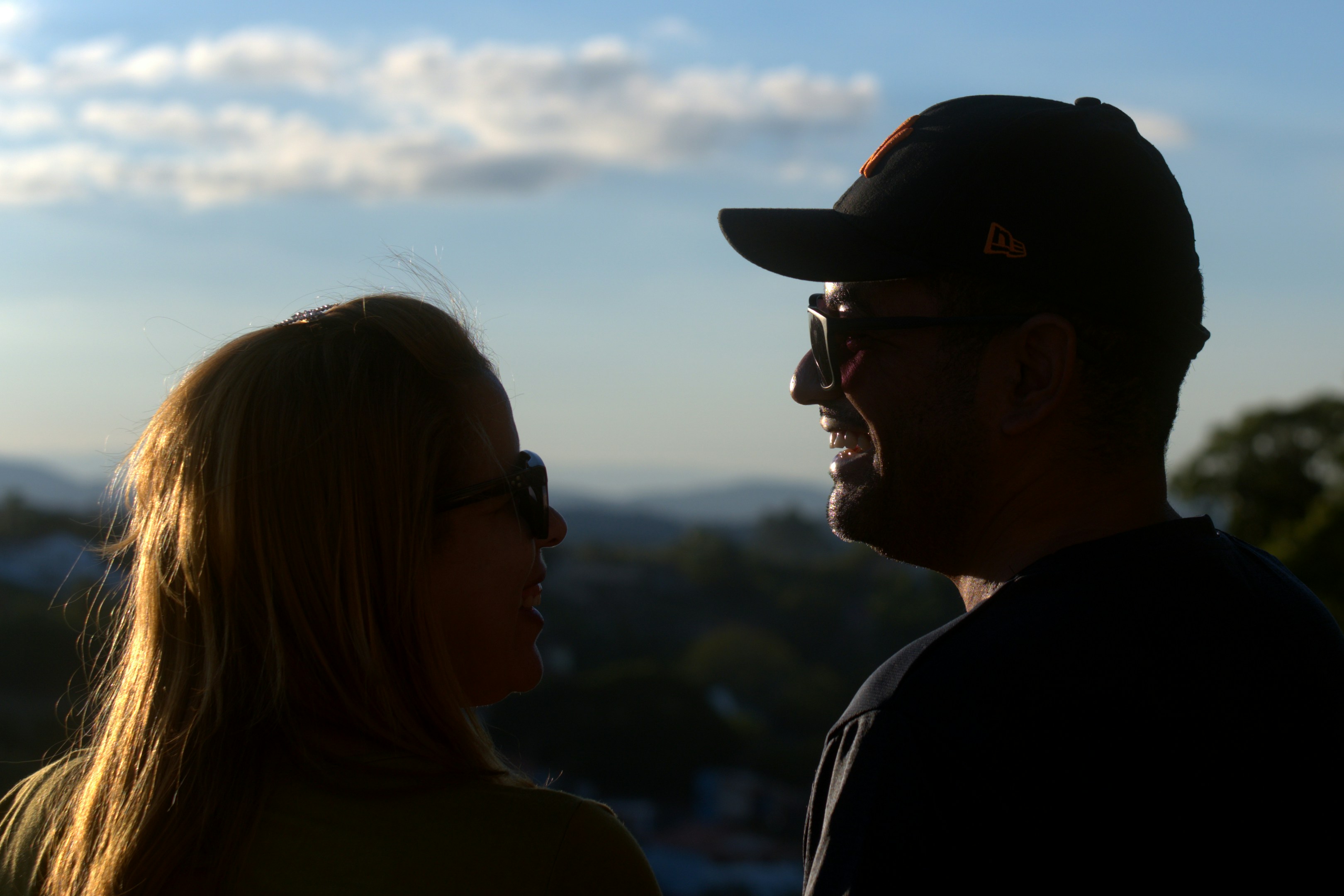 Couple looking at each other with a scenic background