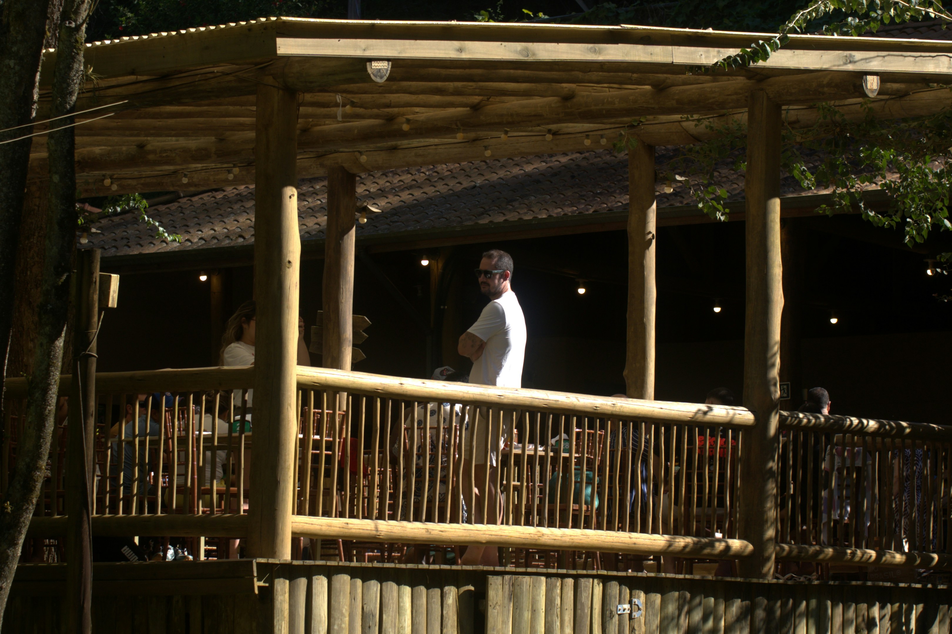 Man standing on a wooden deck with bamboo structure