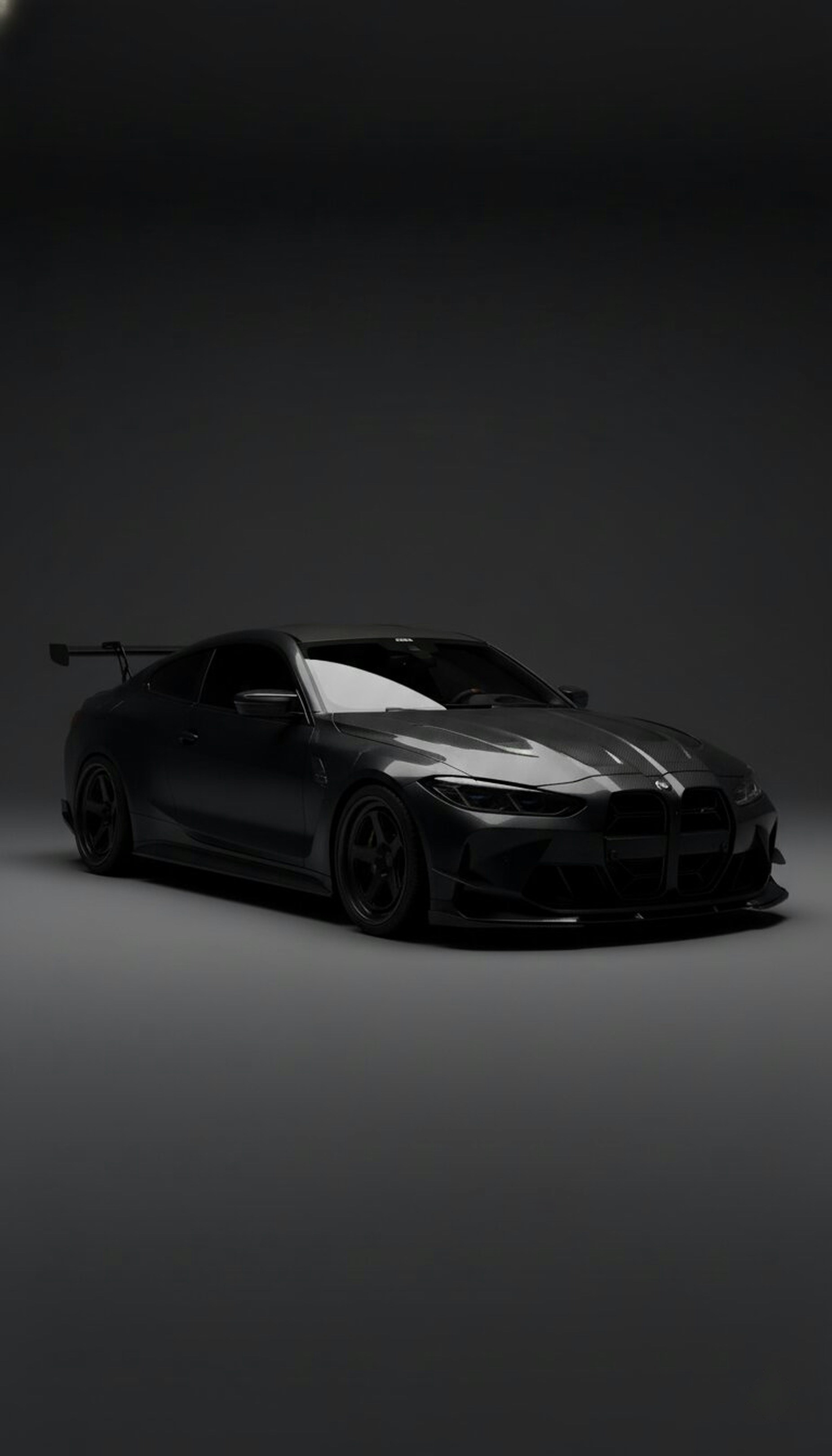 A dark grey sports car with a spoiler