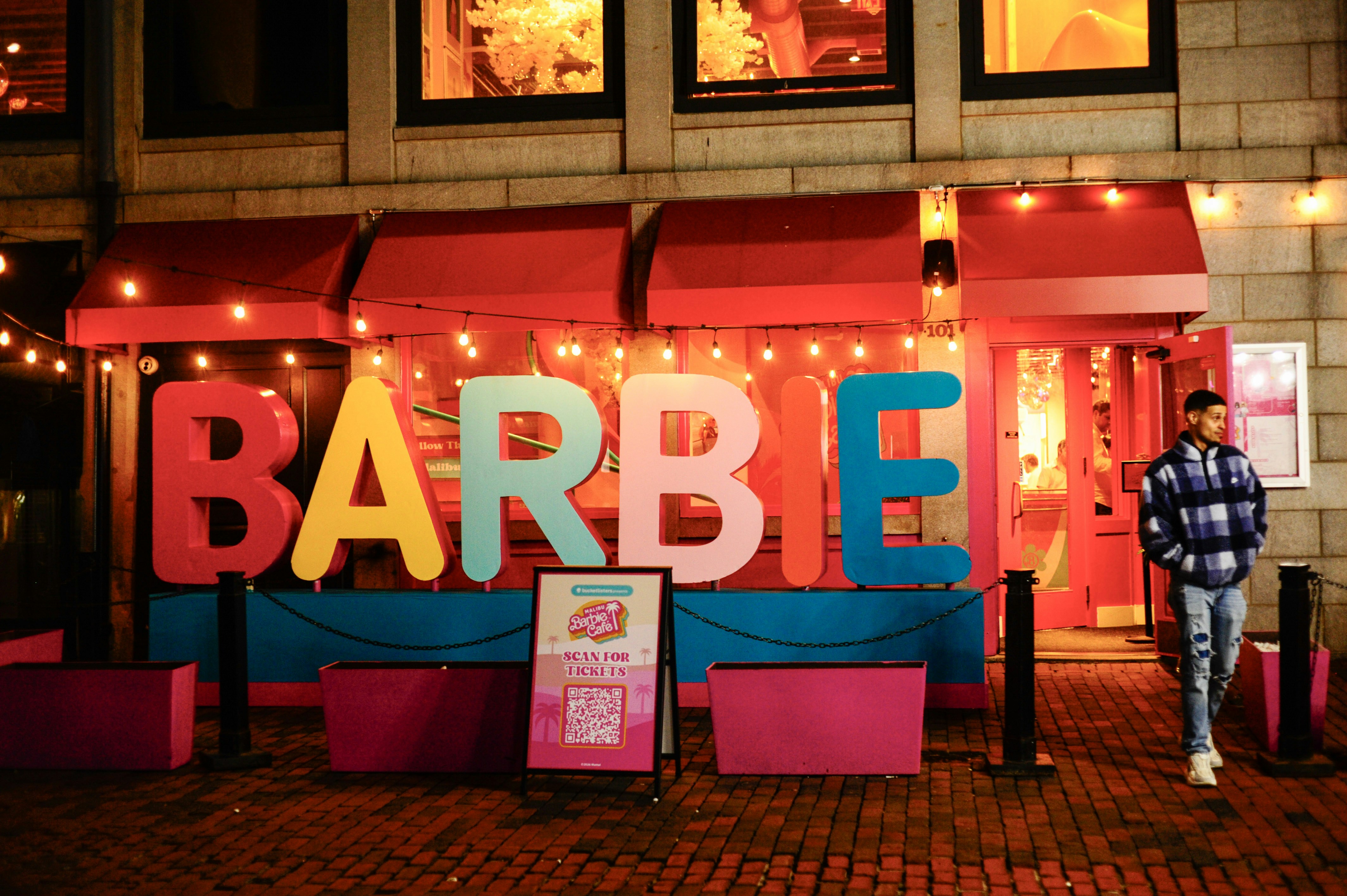 Barbie storefront with a person walking by
