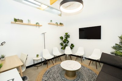 A modern, uncluttered waiting room with plants