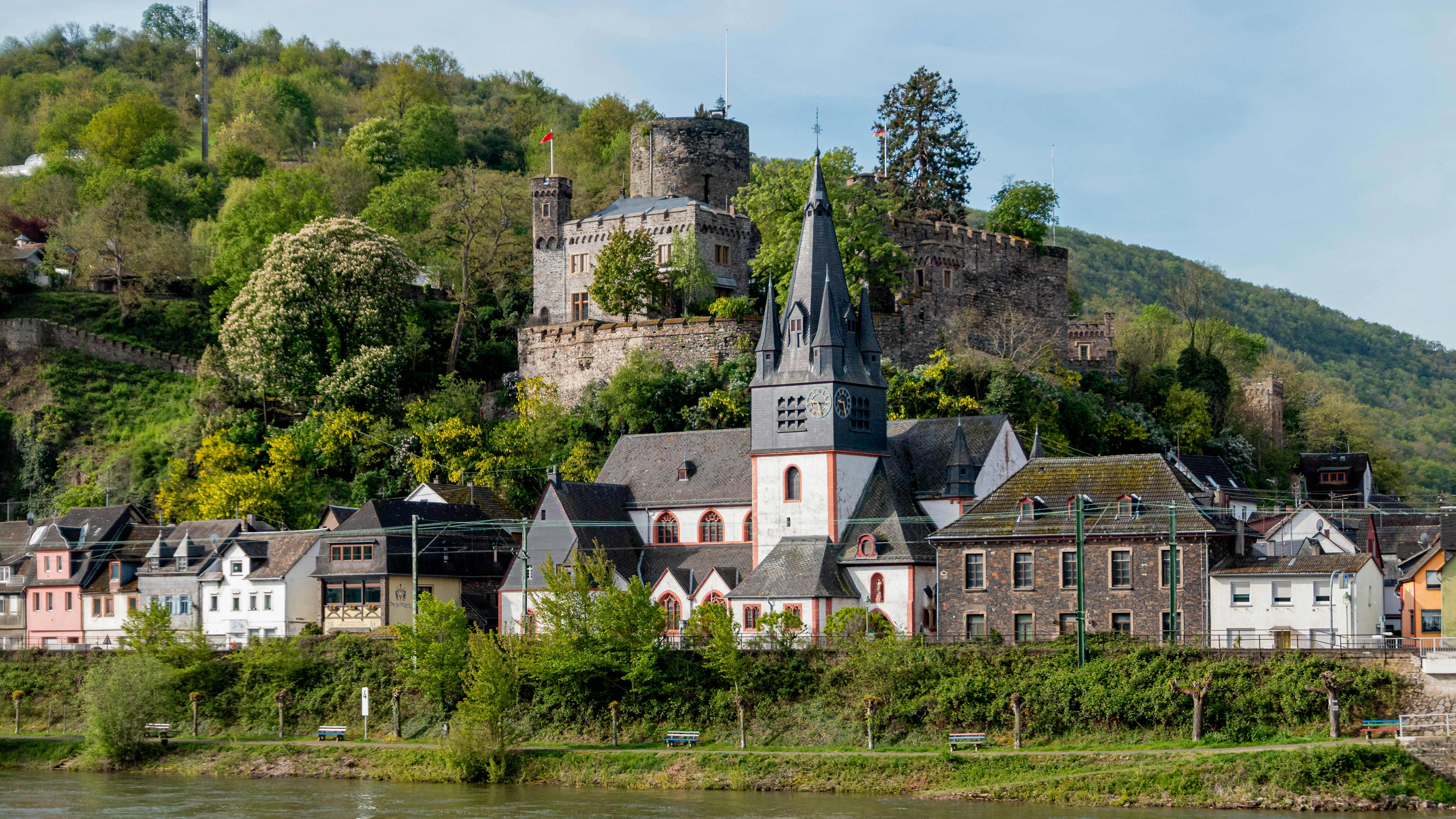 Historic village with castle ruins on a hill.