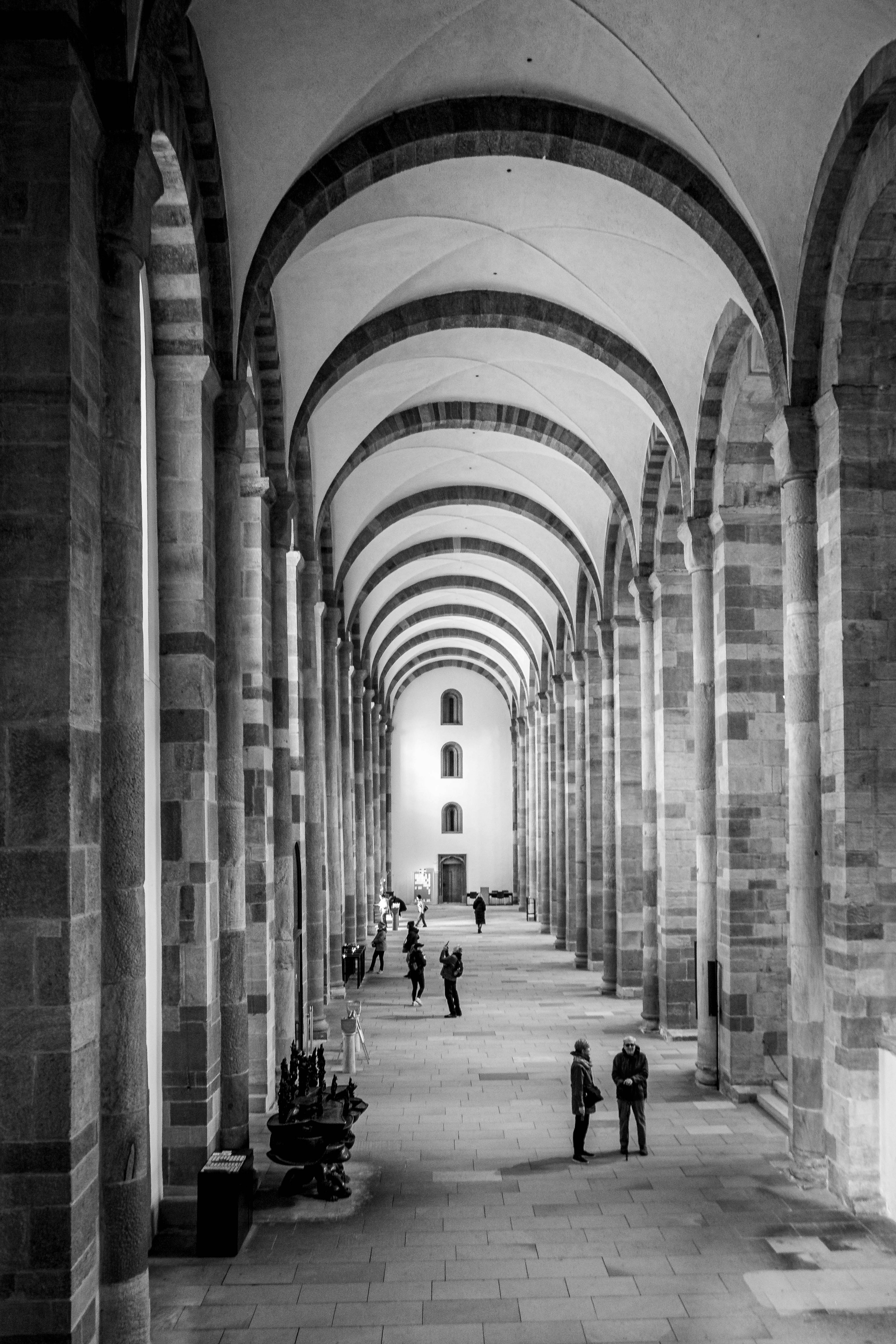Long arched hallway with people walking inside