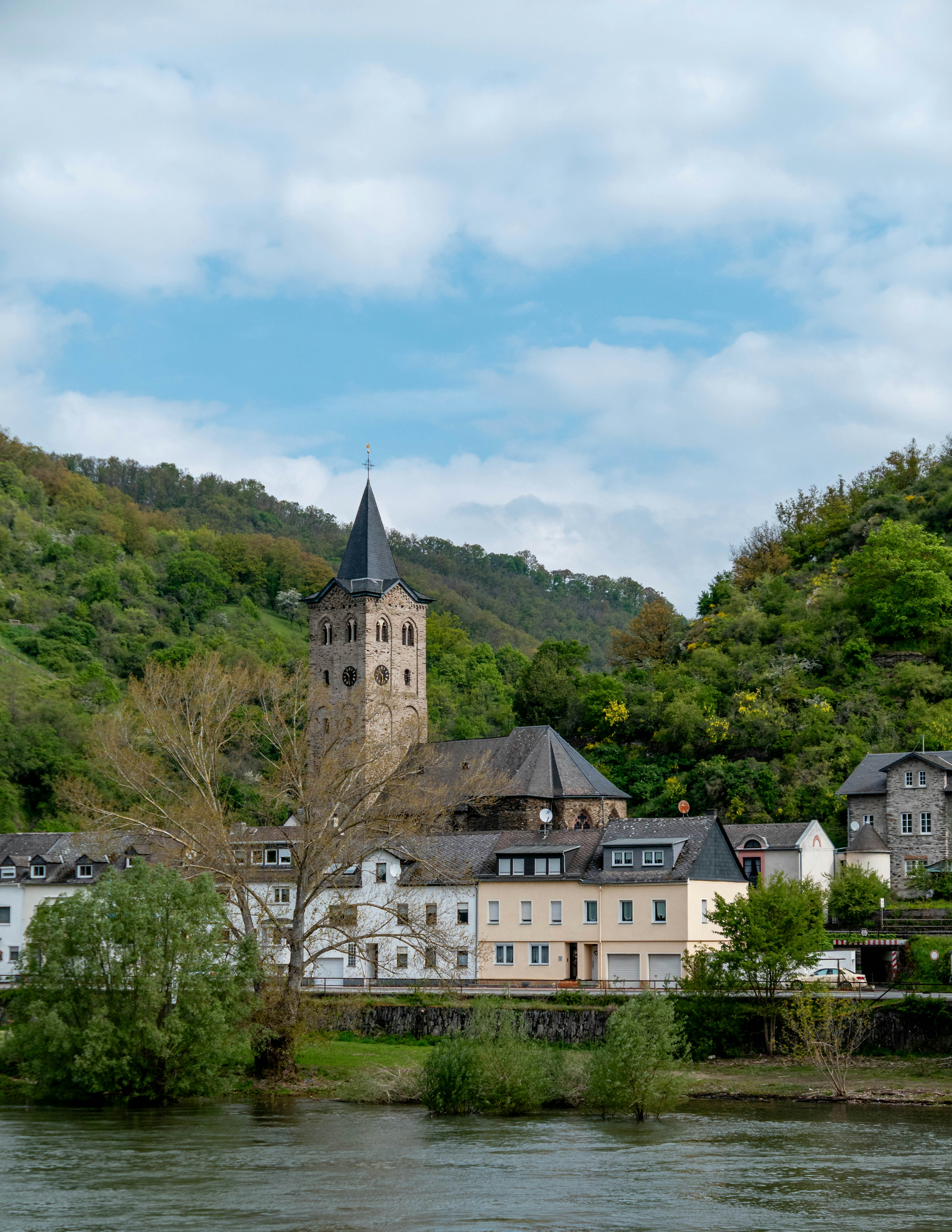 Village with church tower beside a river