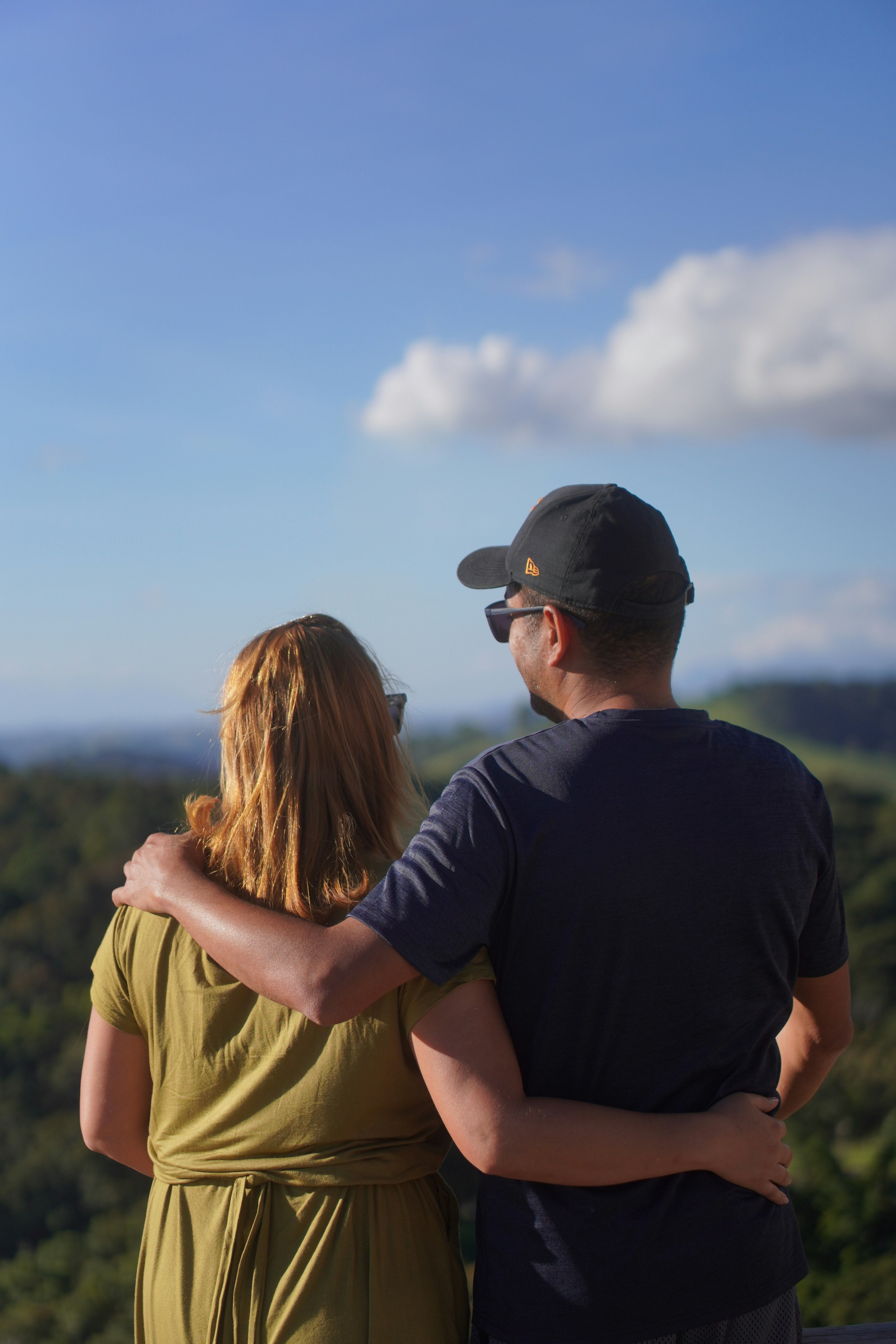 Couple embracing and looking out at a scenic view