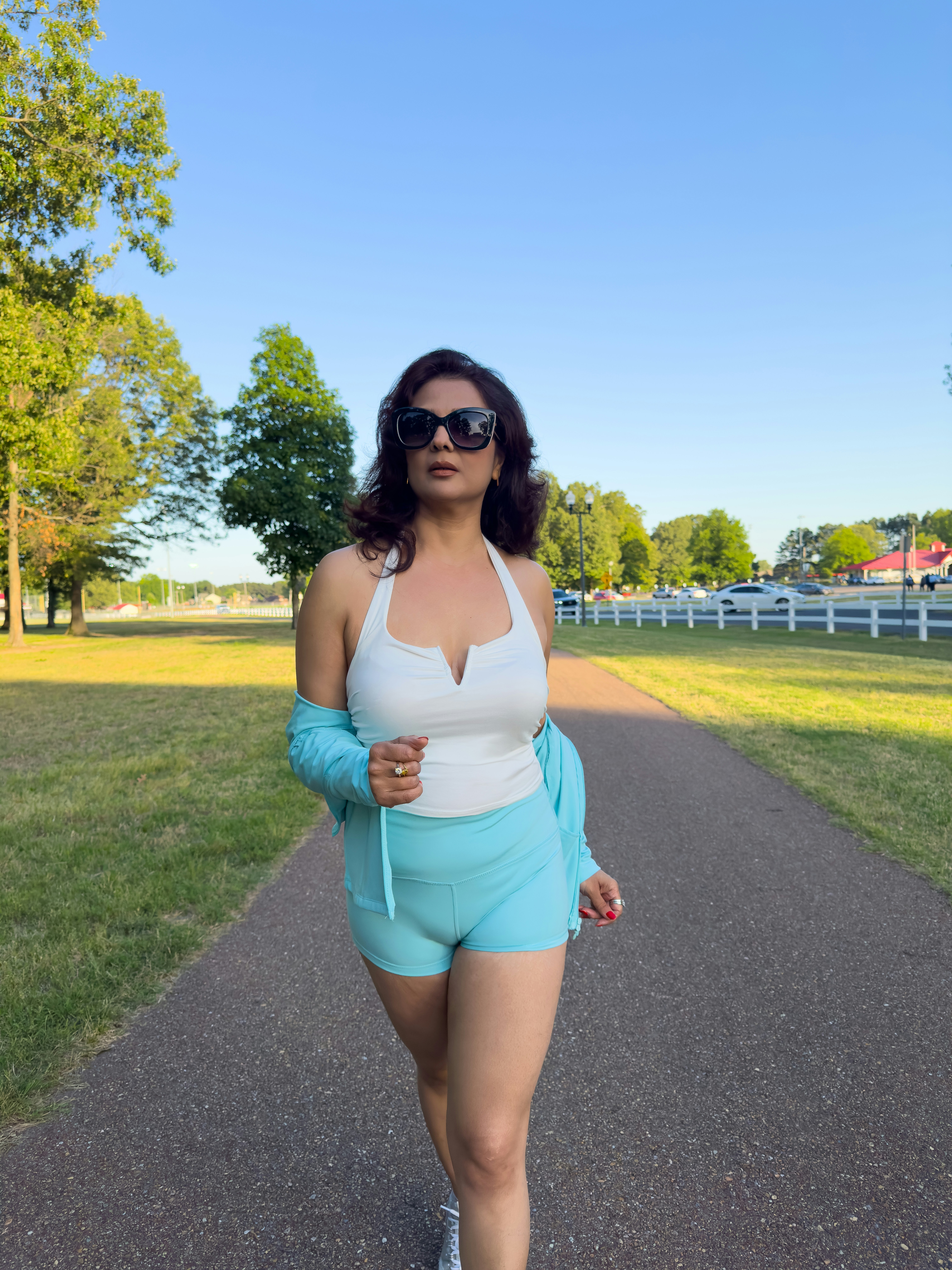 Woman walking on a park path, representing movement and a healthy routine after a breakup