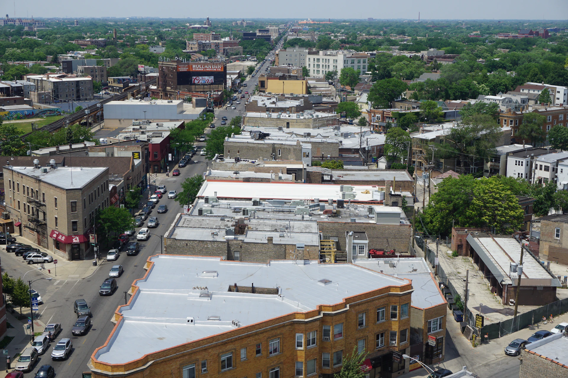 Urban street scene with buildings and cars.