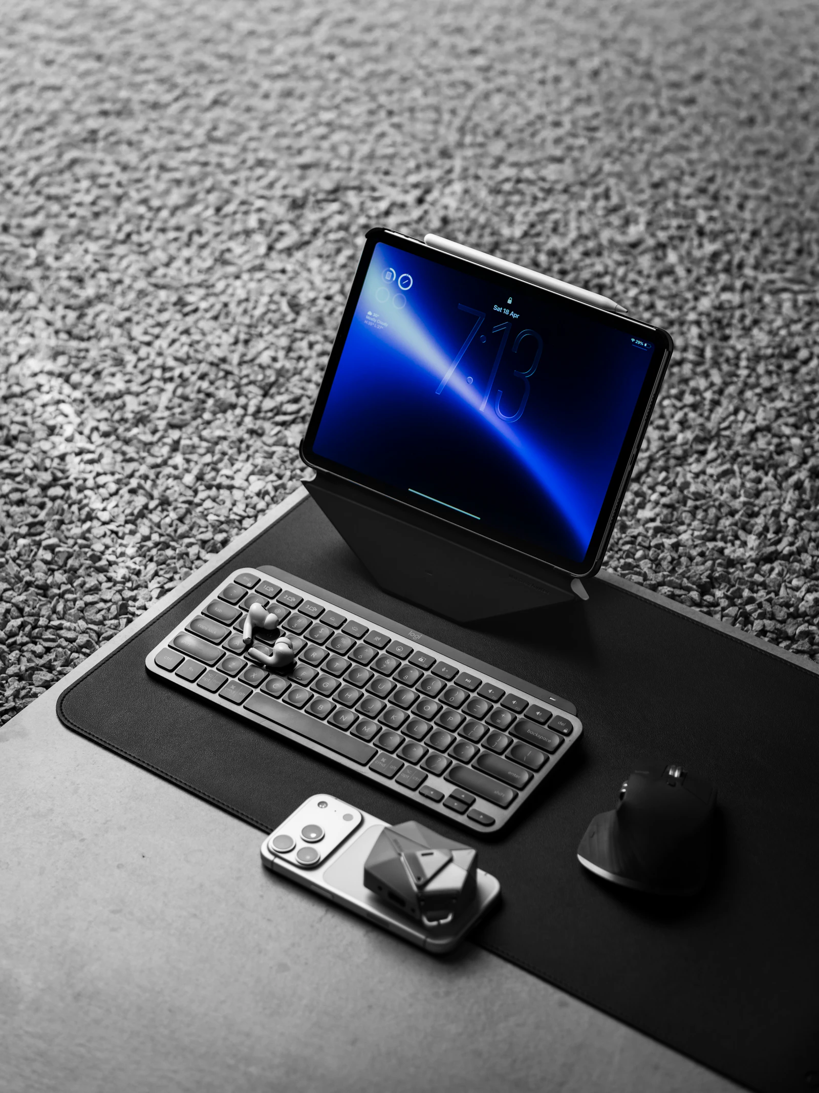 A tablet paired with a wireless keyboard and mouse arranged on a clean desk, evoking a minimalist iPad accessory setup