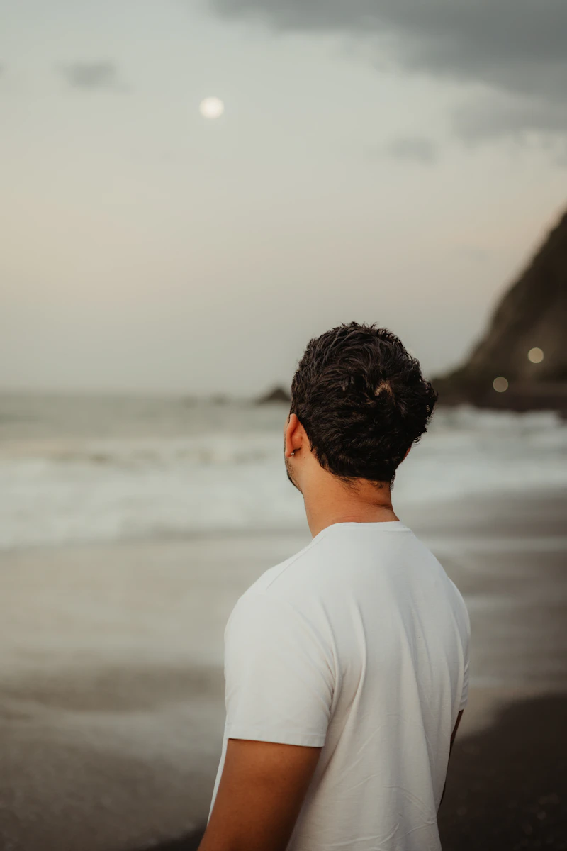 Man in white linen shirt by the ocean