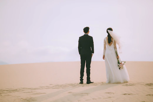 Bride and groom standing in a desert landscape