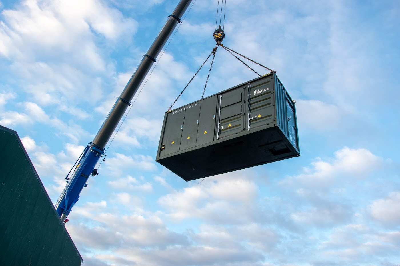 Kran hebt einen Container für Energiespeicher