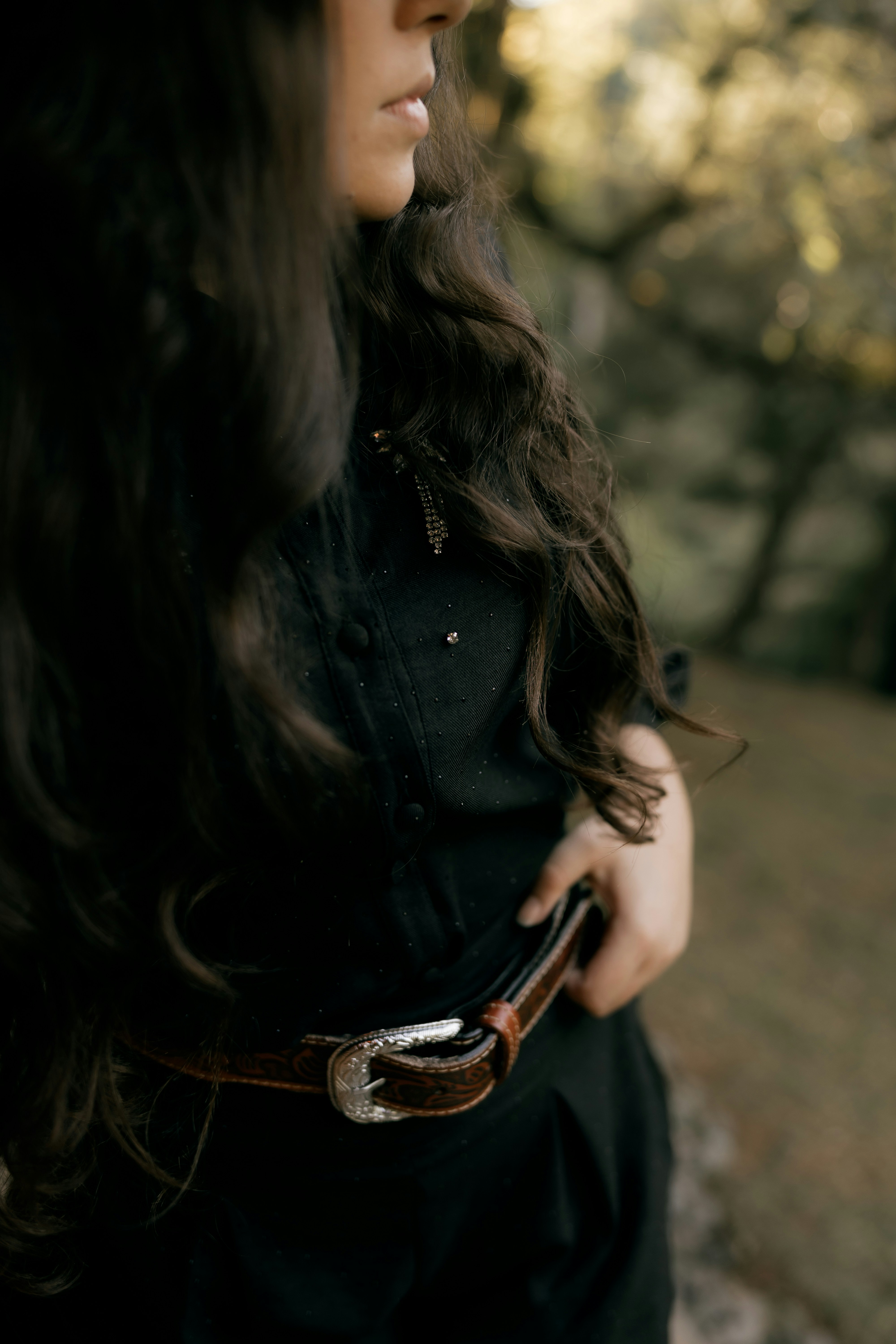 Woman in black dress with ornate belt
