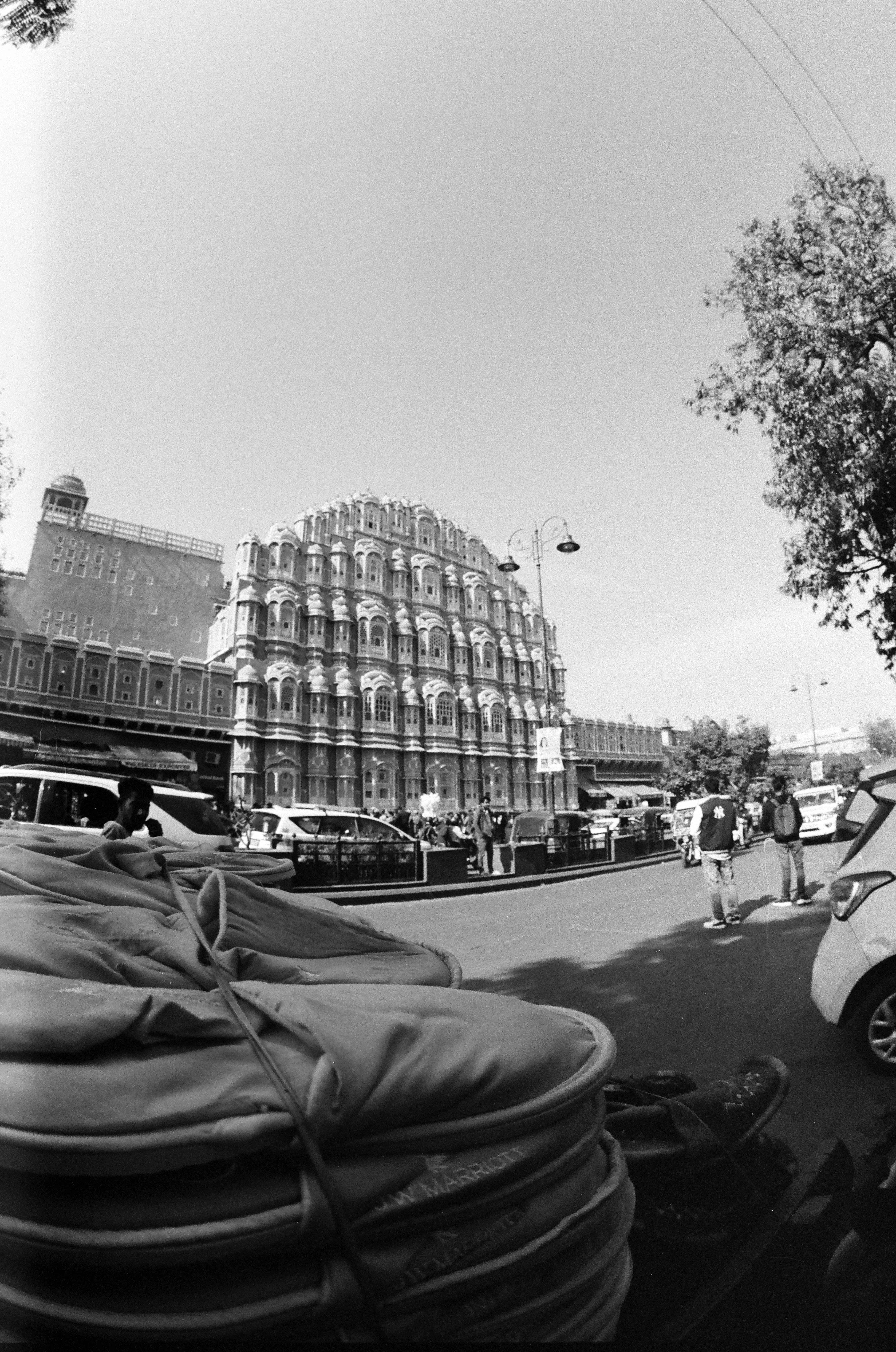 Hawa mahal building on a busy street in jaipur.