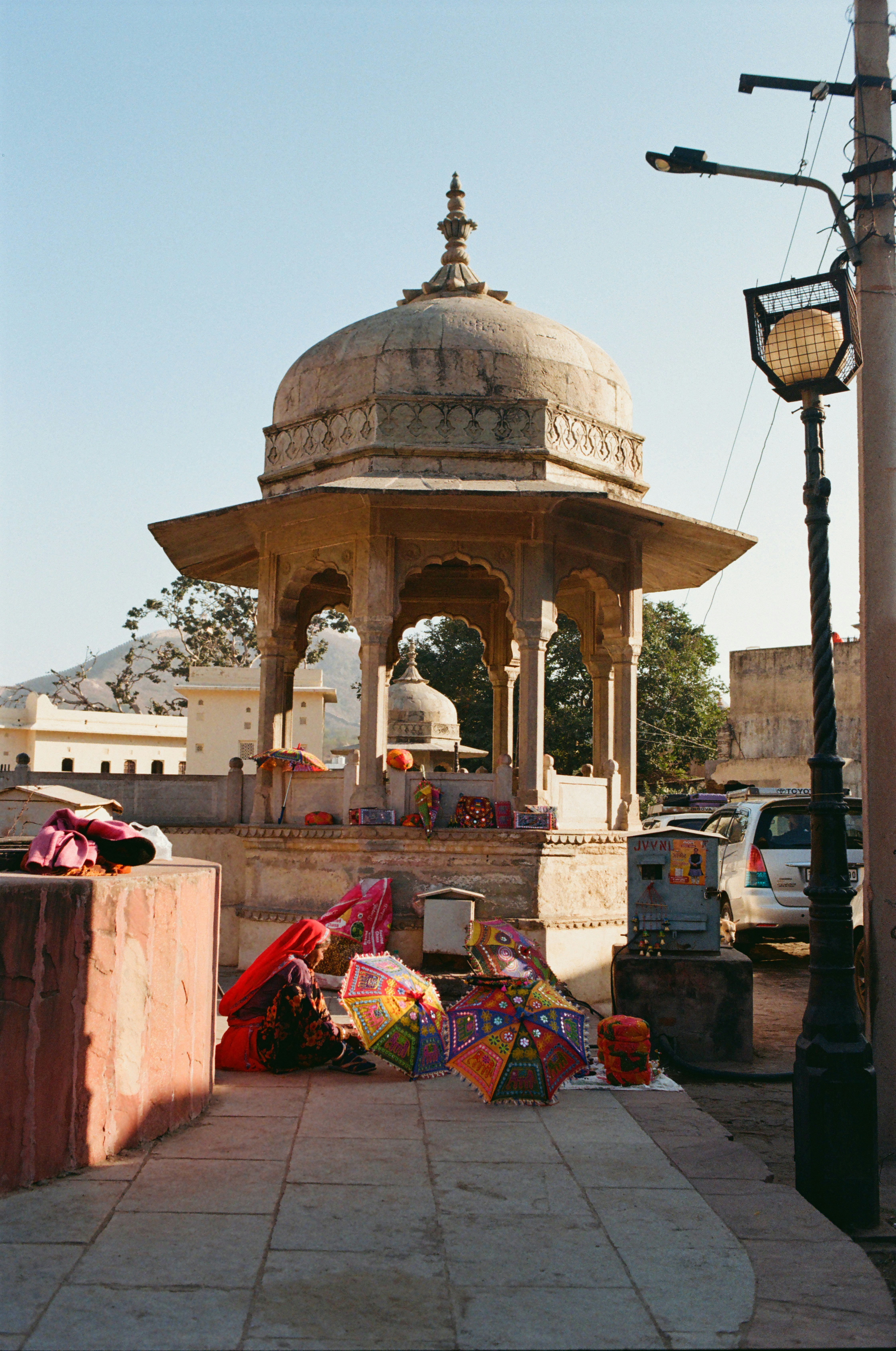 Ornate stone pavilion with colorful umbrellas displayed