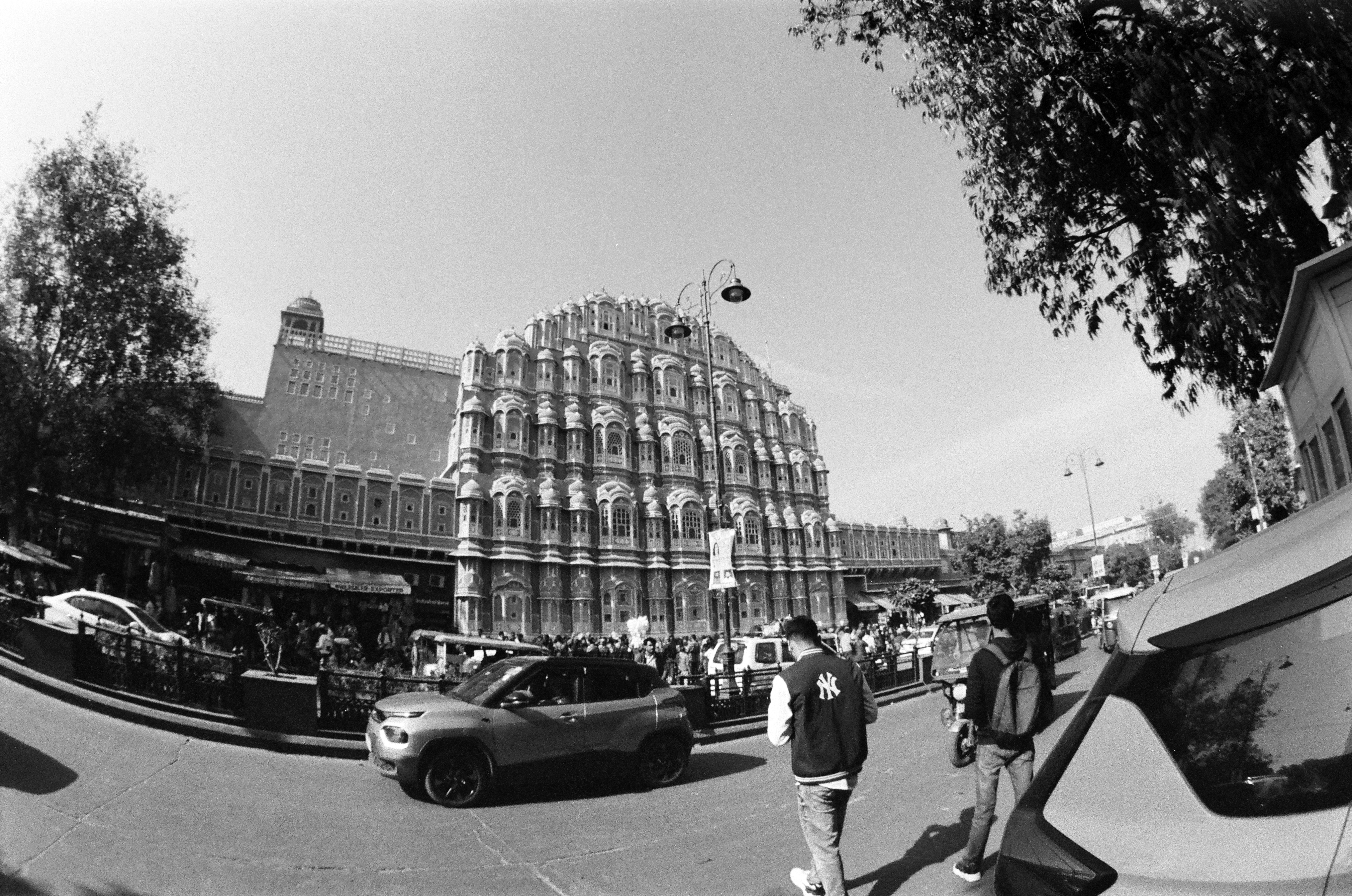 Busy street scene in front of ornate building
