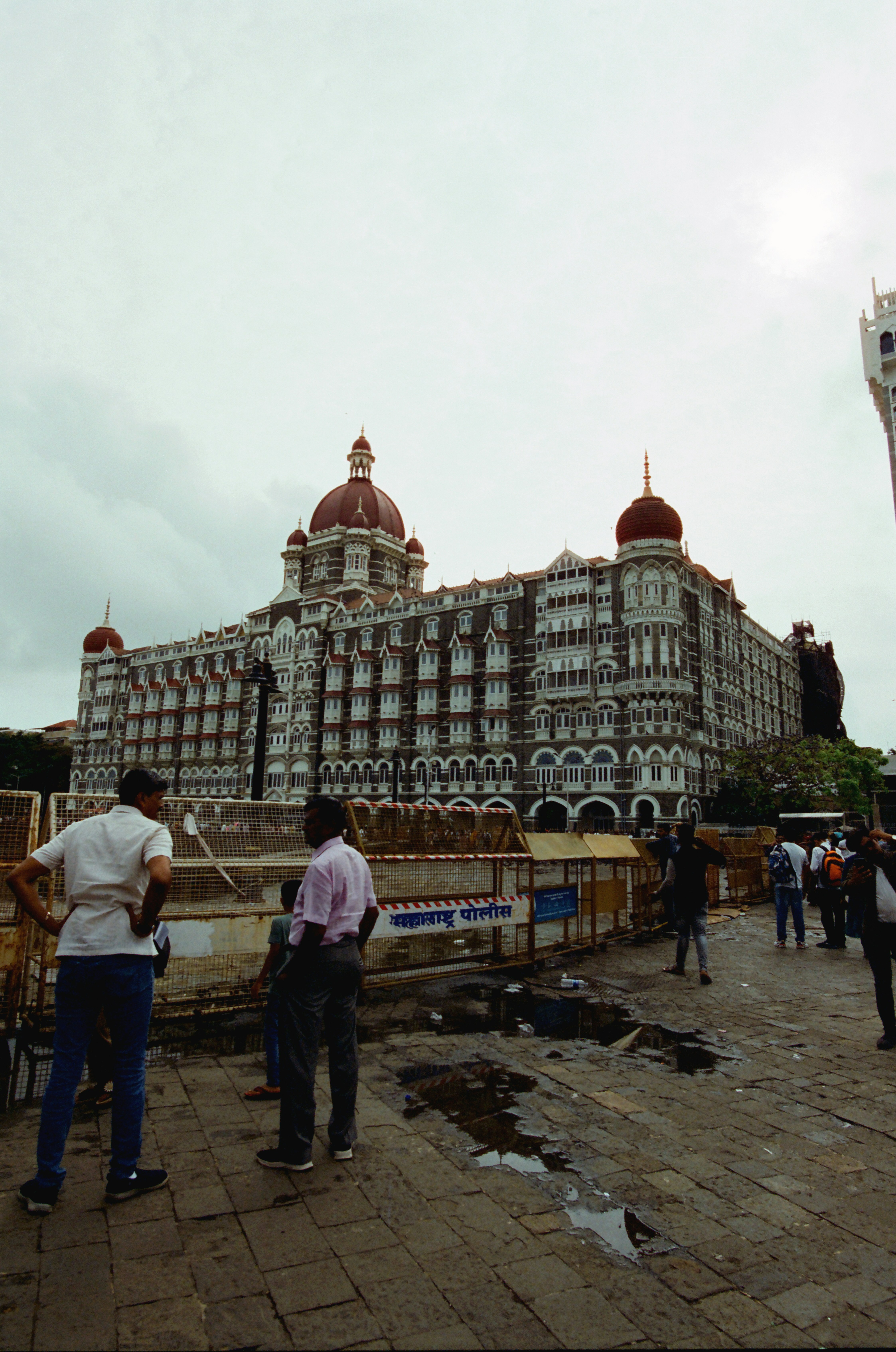 Grand hotel with people outside on cloudy day
