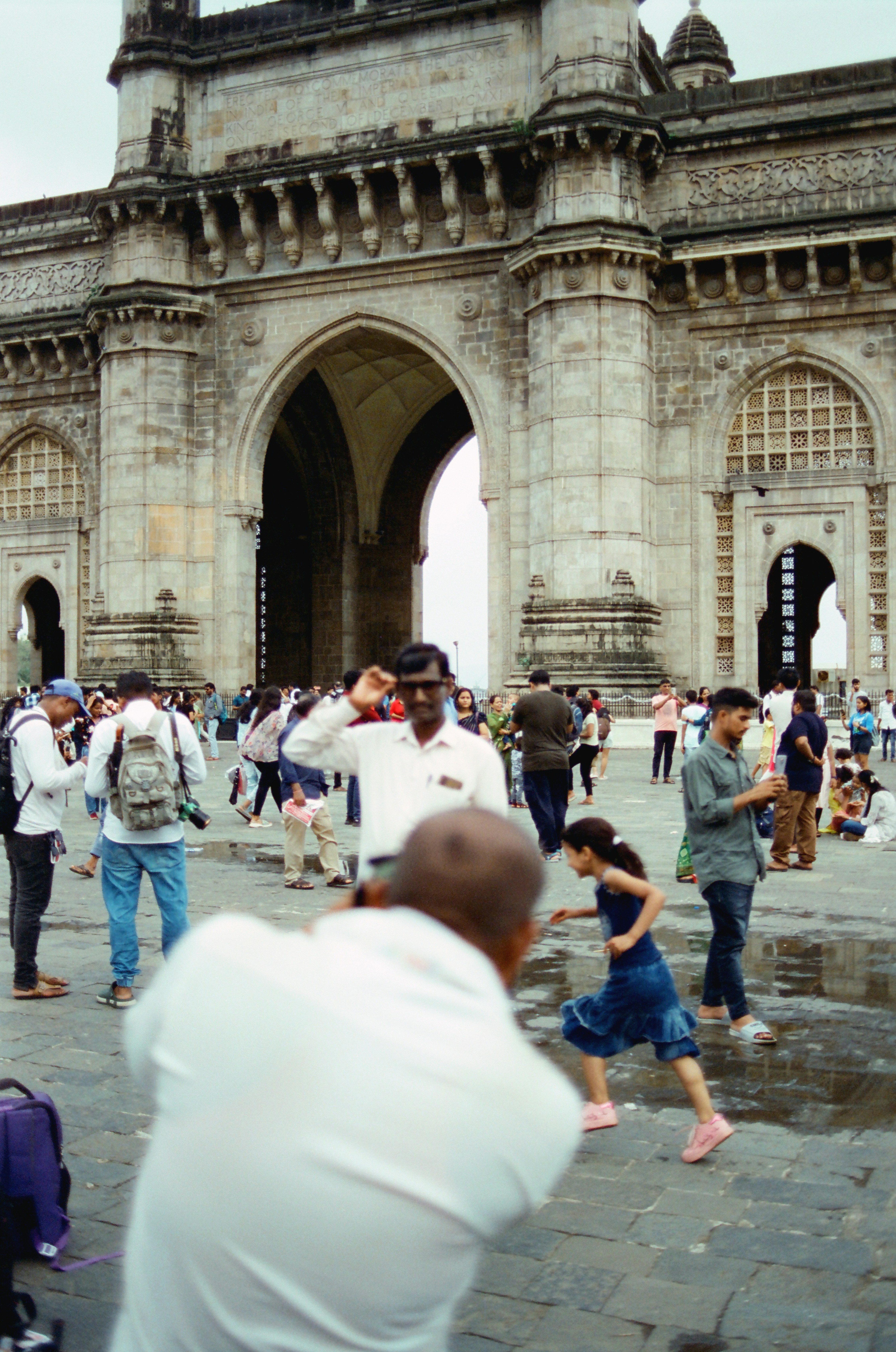 People gather at the gateway of india monument.