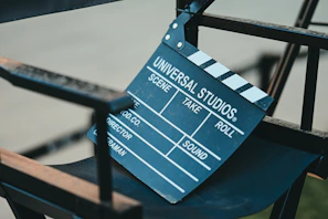 A clapperboard rests on a director's chair.
