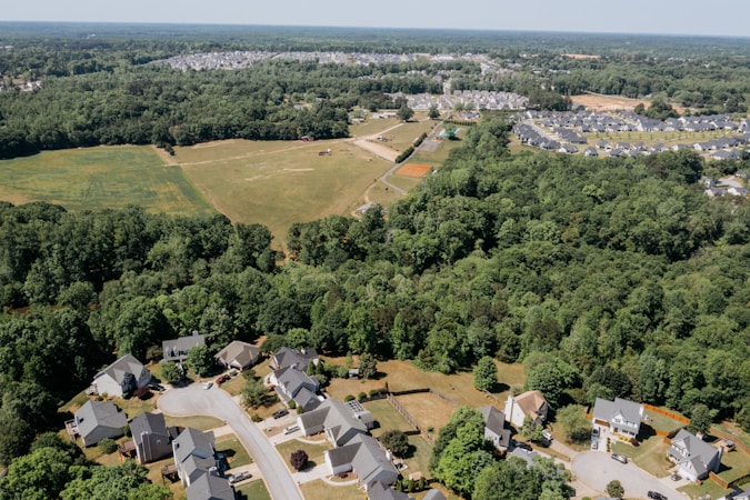 Aerial view of a suburban neighborhood at the edge of open land, illustrating how local submarkets can move differently from a multi-state regional average