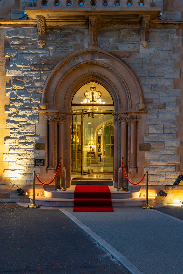 A grand entrance with a red carpet and velvet ropes