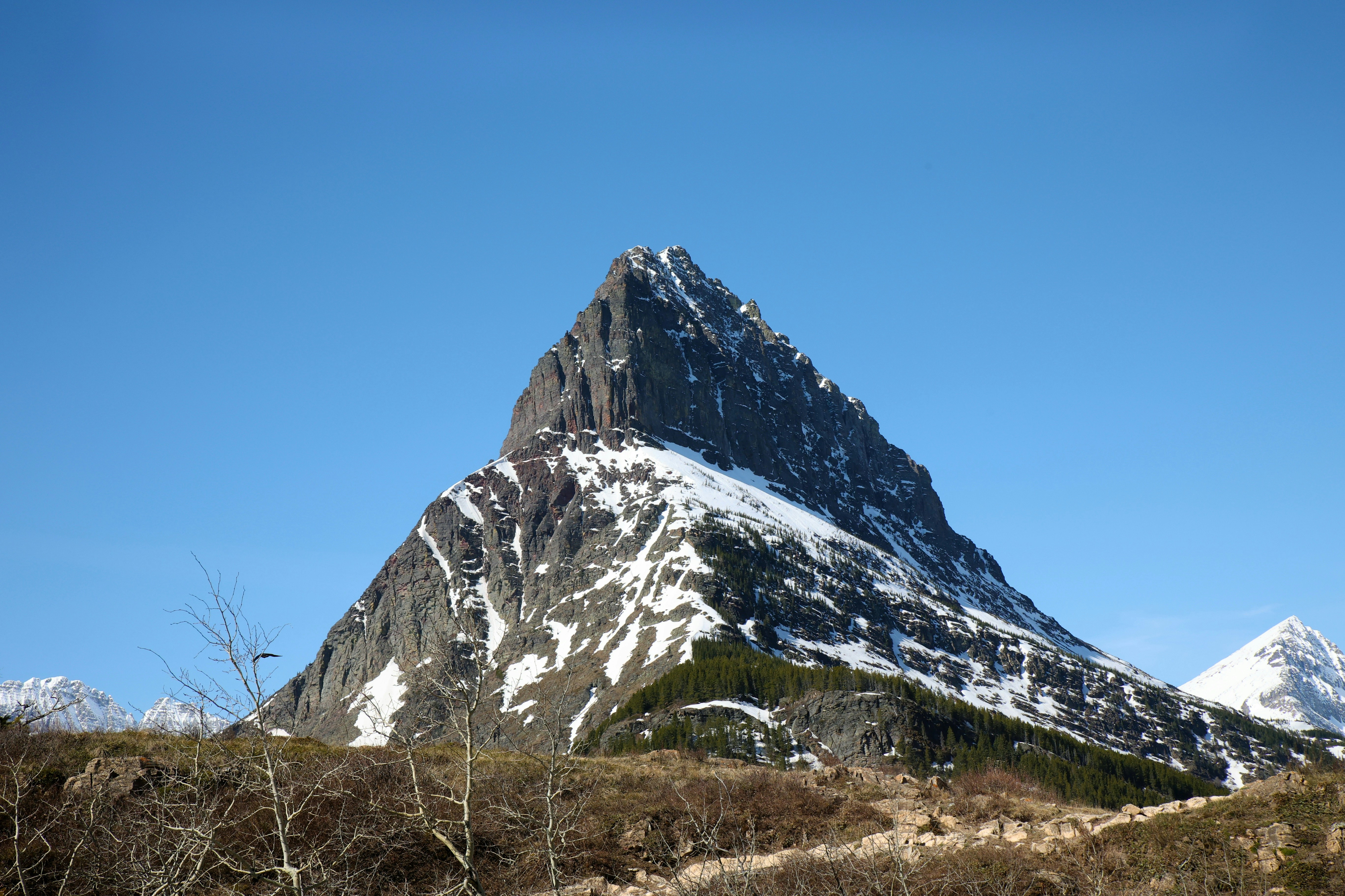 A majestic snow-capped mountain under a clear blue sky