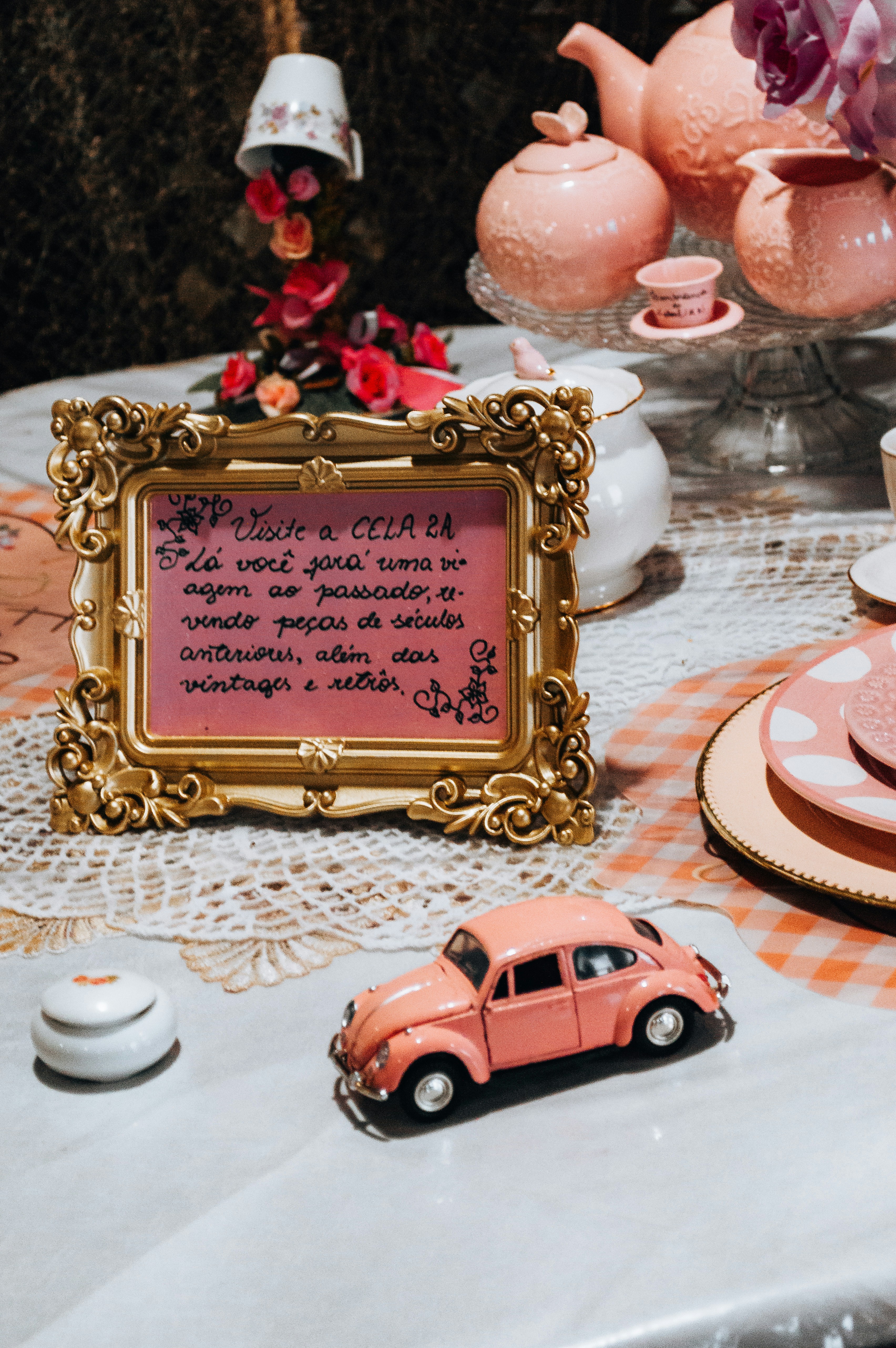 Pink vintage car and framed quote on table