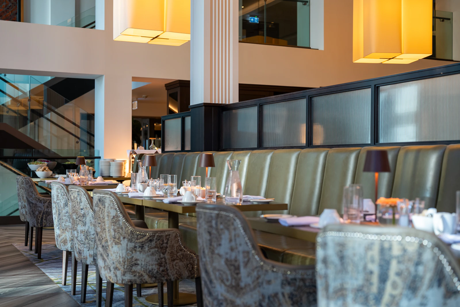 Elegant steakhouse dining room with warm lighting and set tables