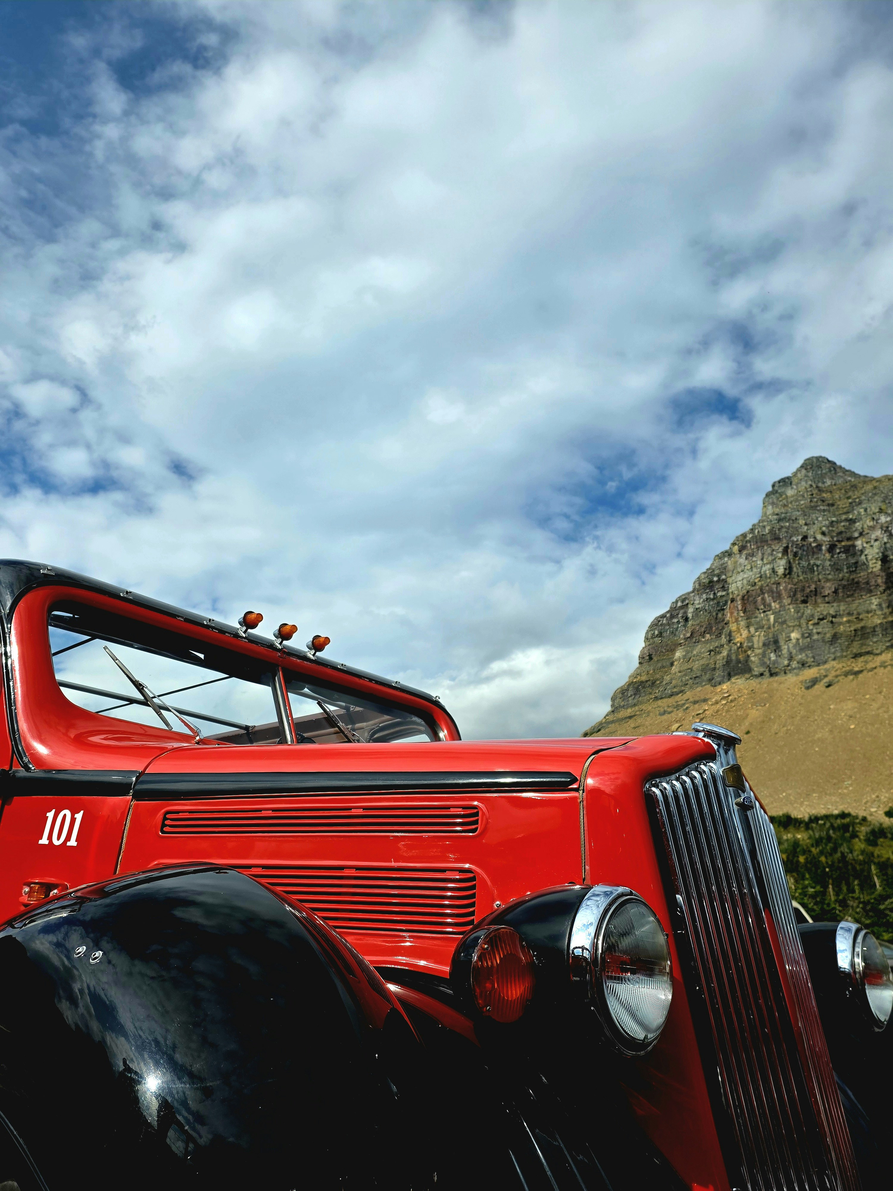 Vintage red truck against a mountain backdrop