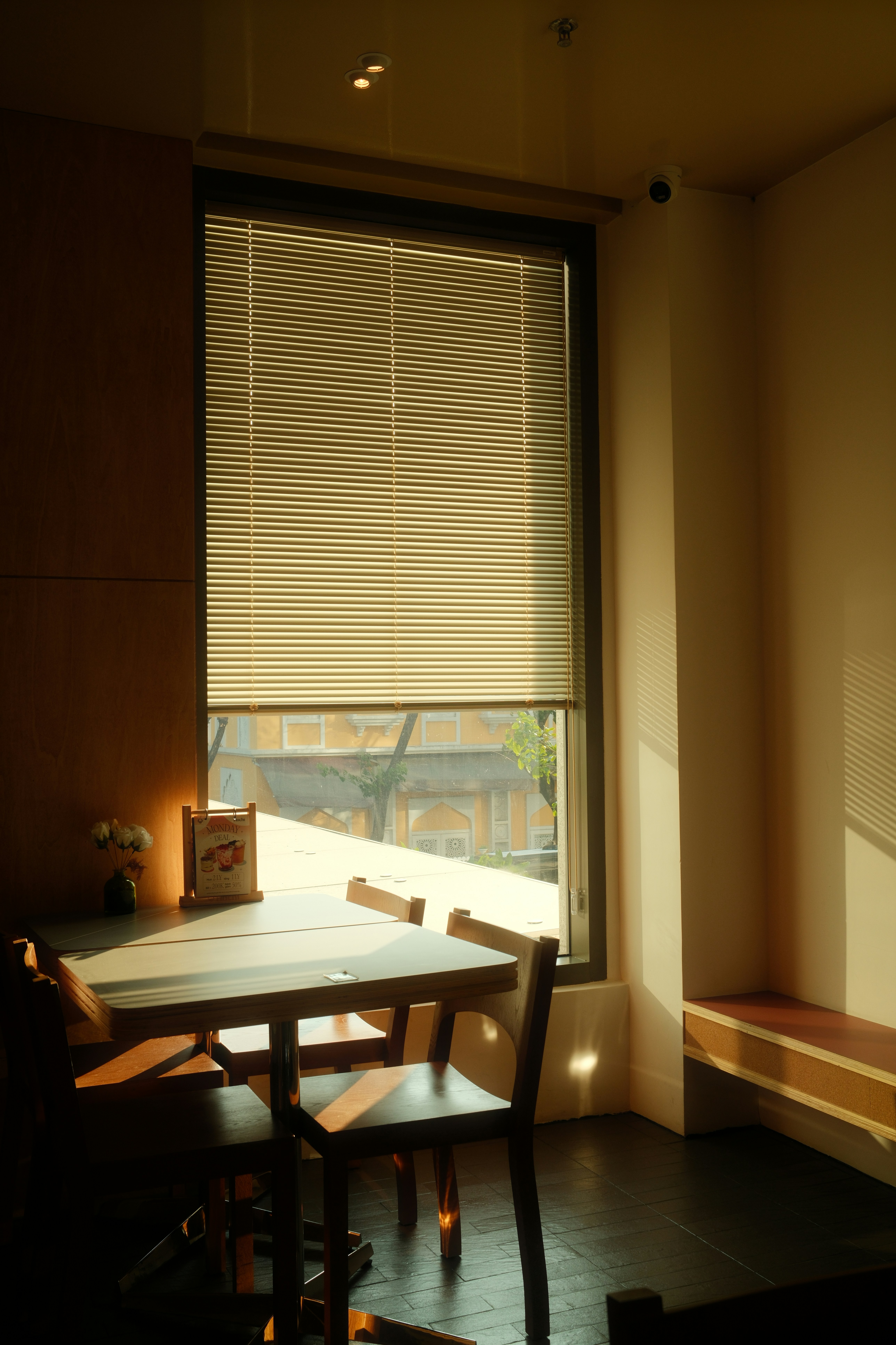 Sunlight streams through a window onto a cafe table.