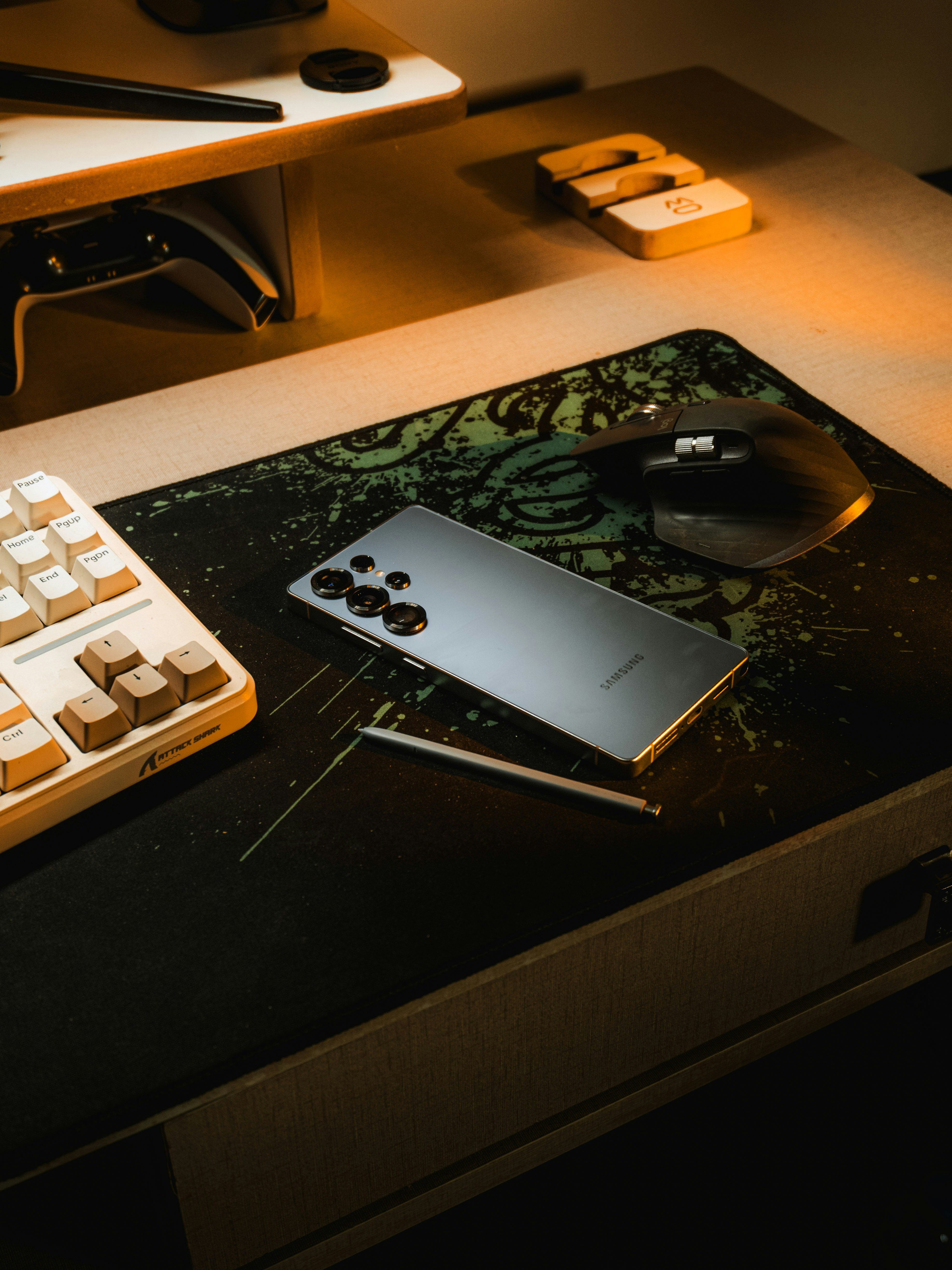Smartphone and stylus on a desk with keyboard and mouse