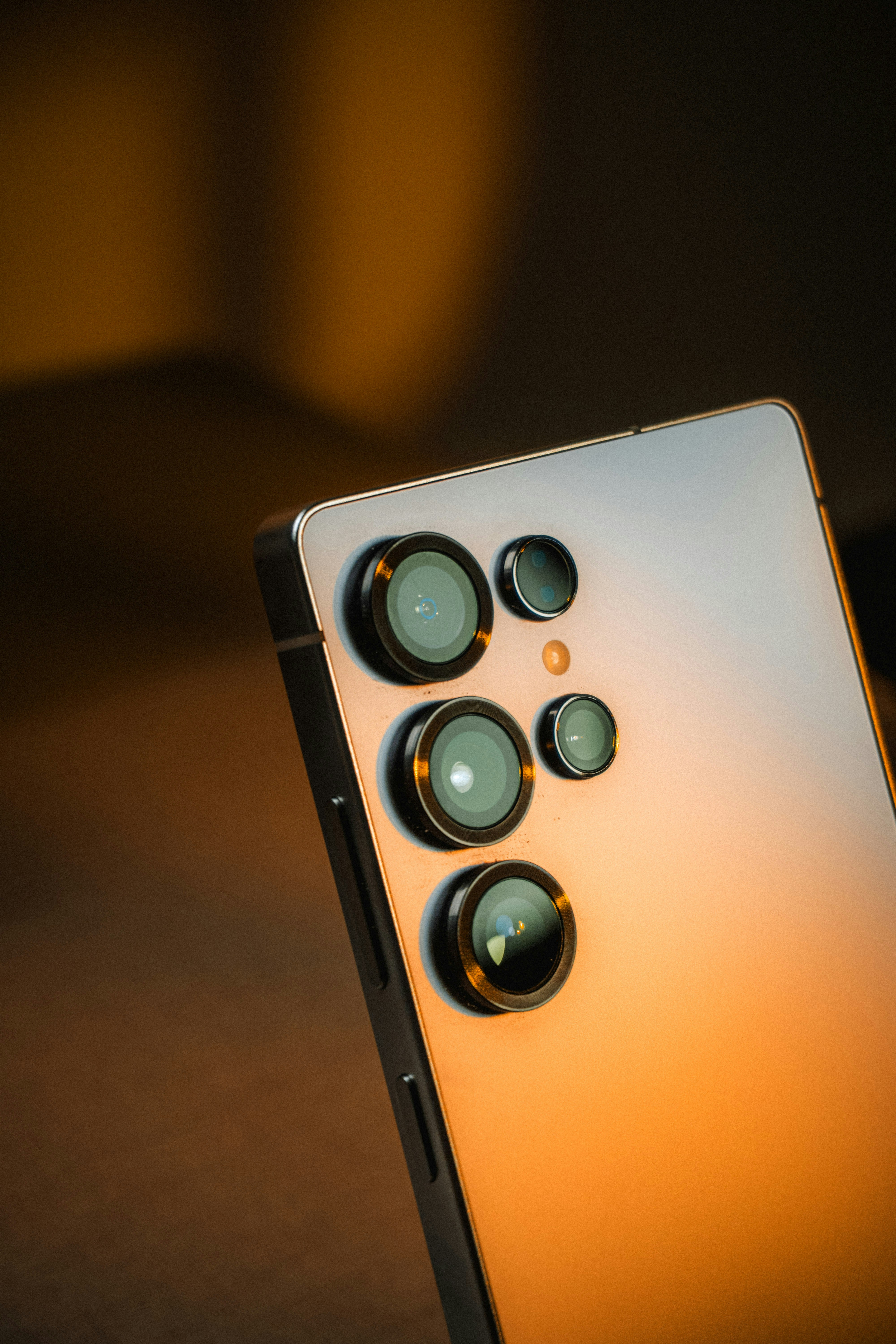 Close-up of a smartphone with multiple camera lenses.