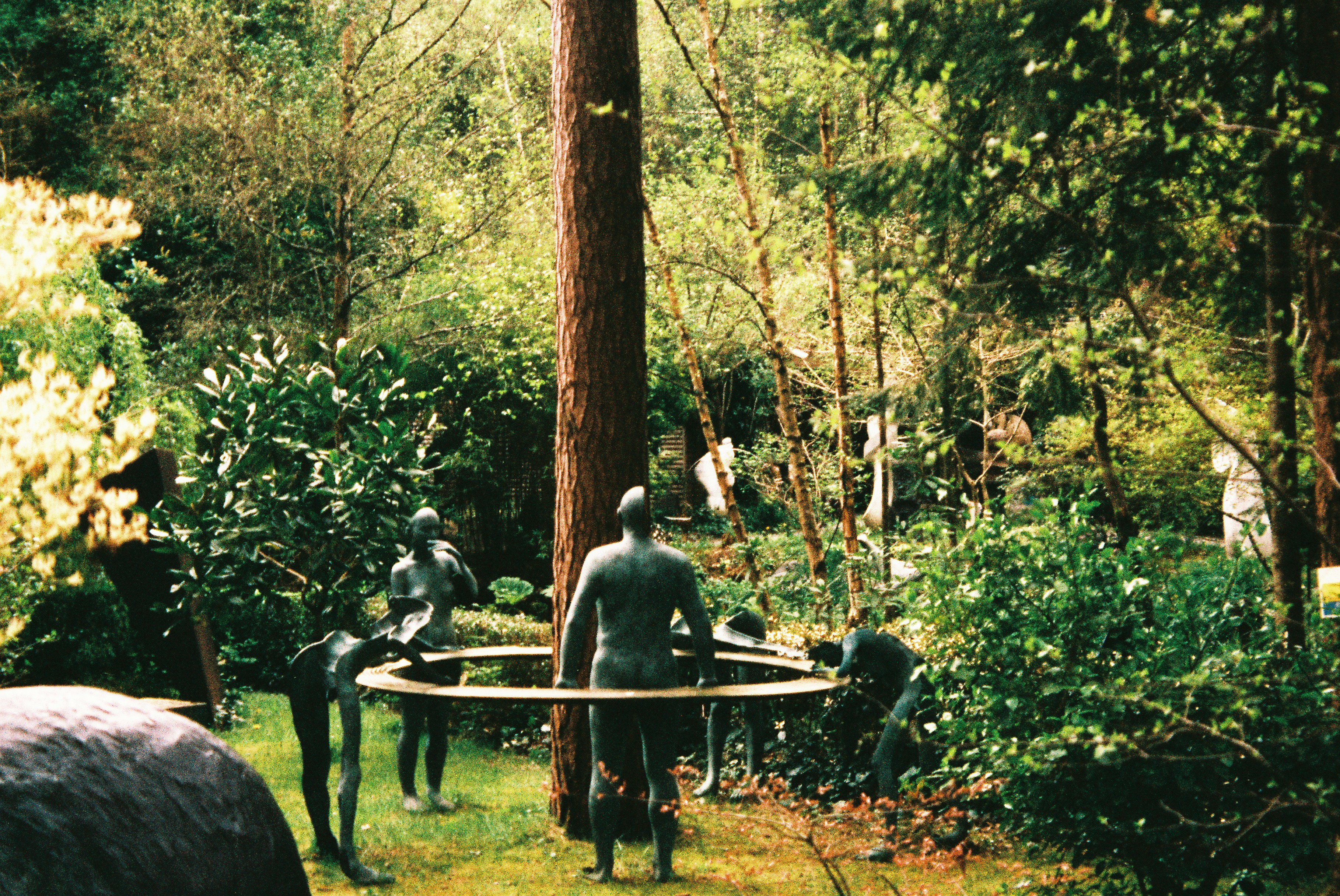Sculptures in a lush green garden setting