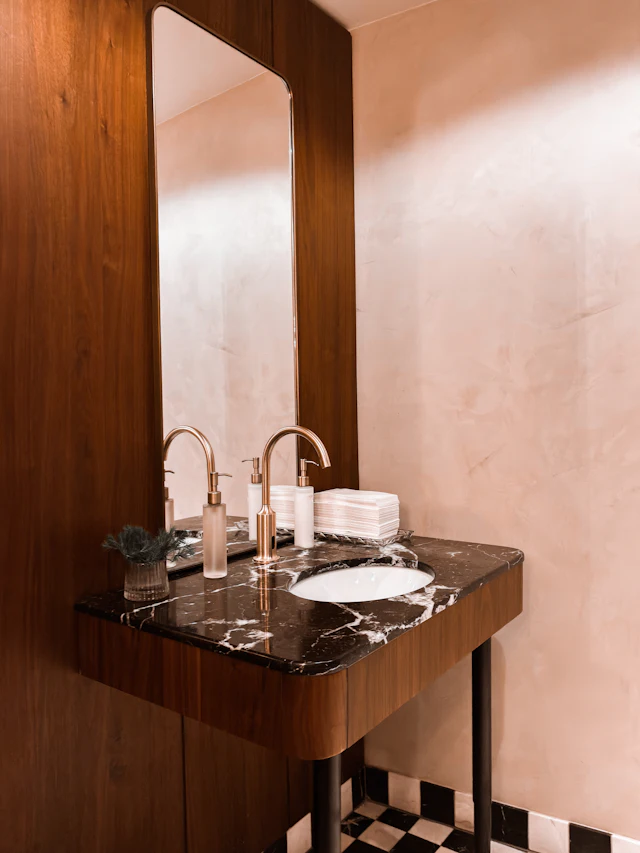 Modern bathroom vanity with marble countertop and brass fixtures