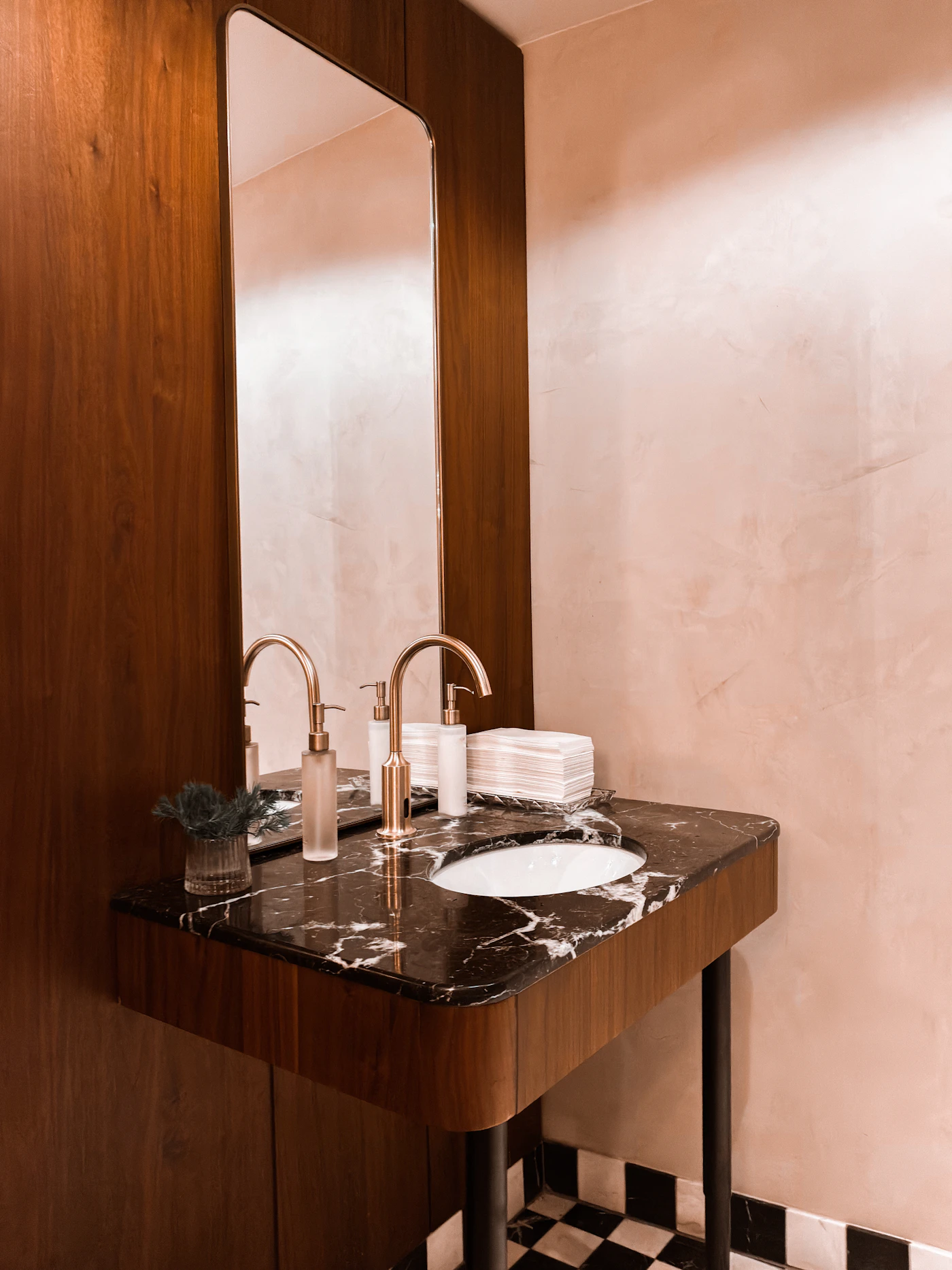 Modern bathroom vanity with warm wood and stone finishes