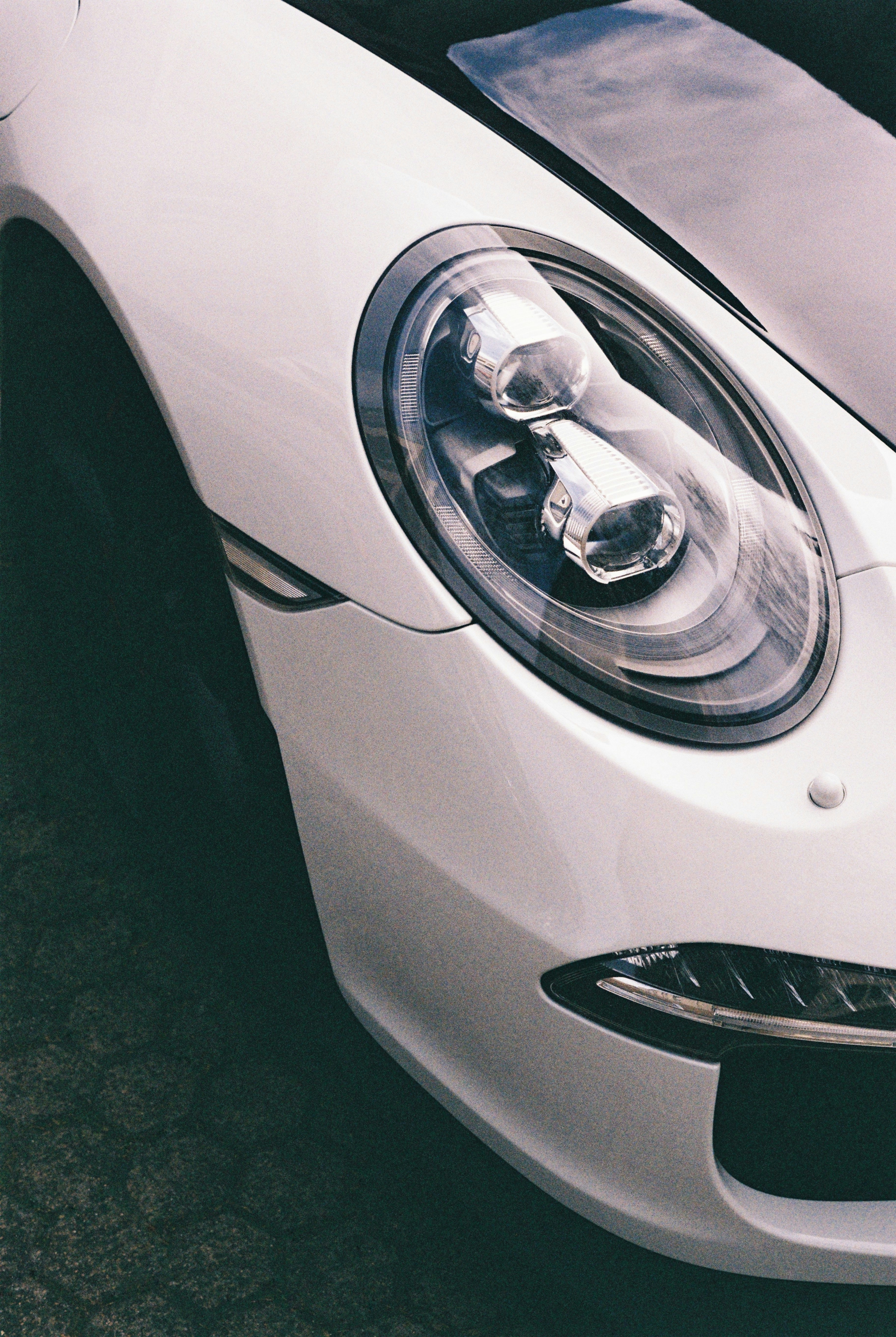 Close-up of a white sports car's headlight