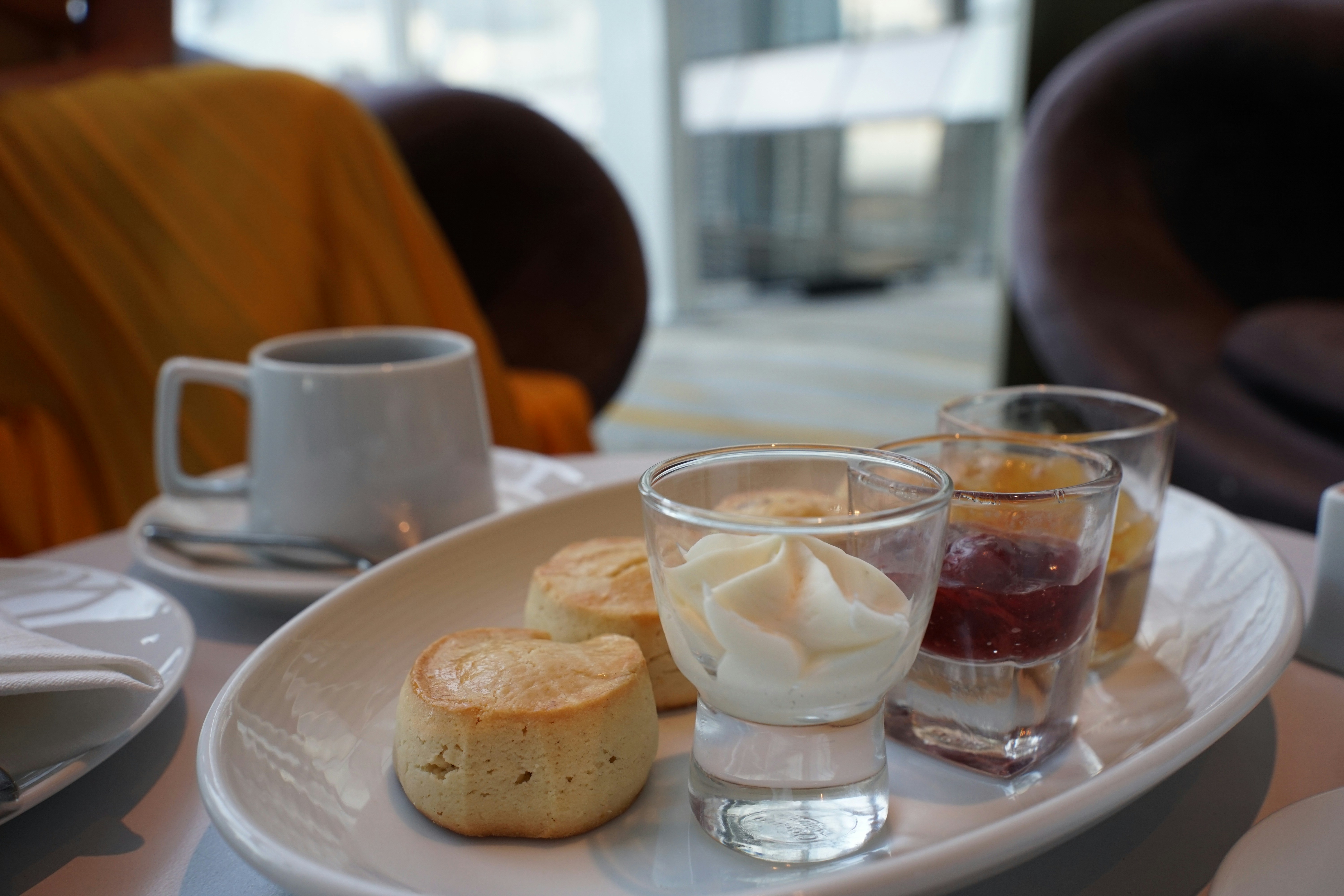 Scones with cream and jam served with coffee.