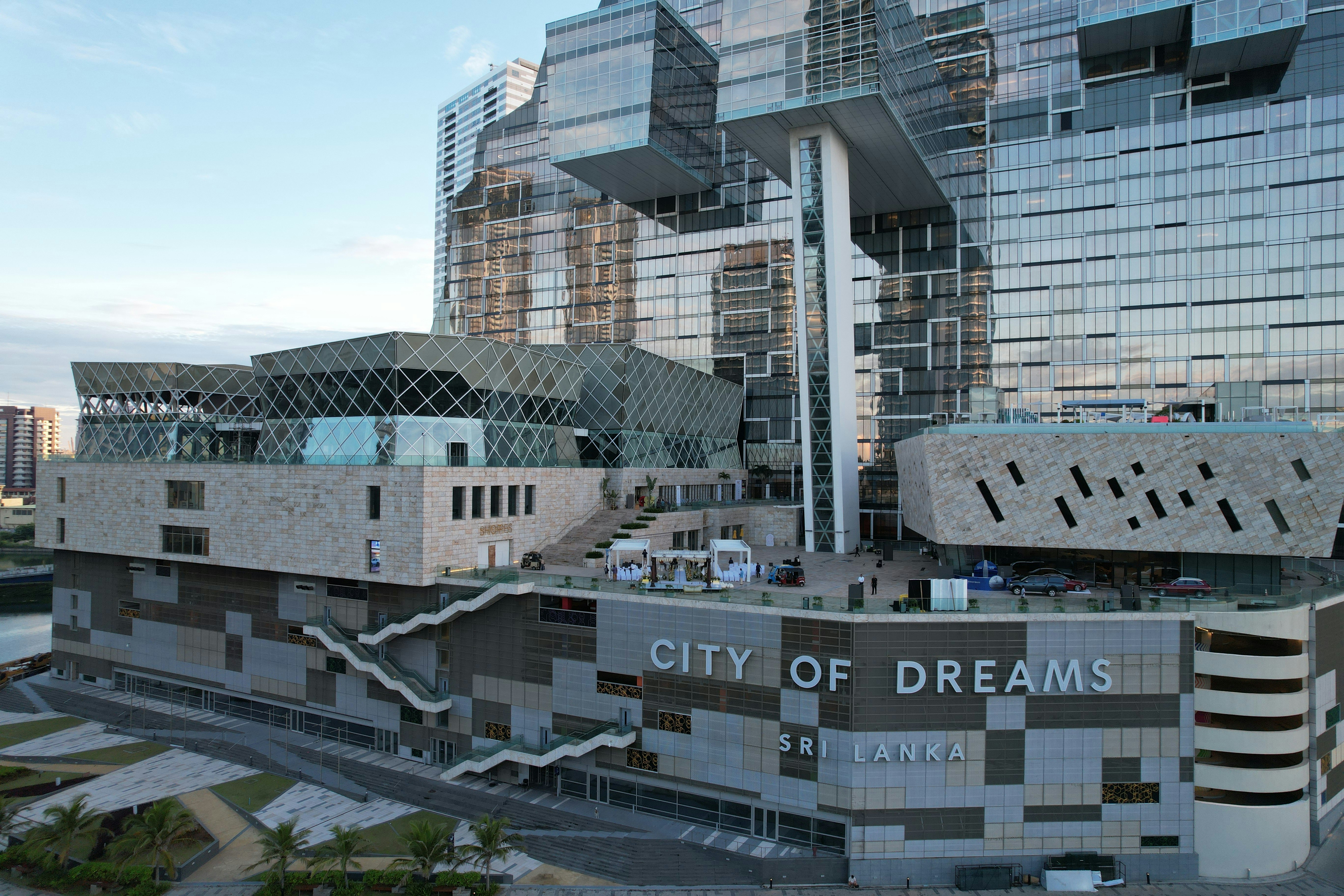 Modern architectural complex with "city of dreams" signage.