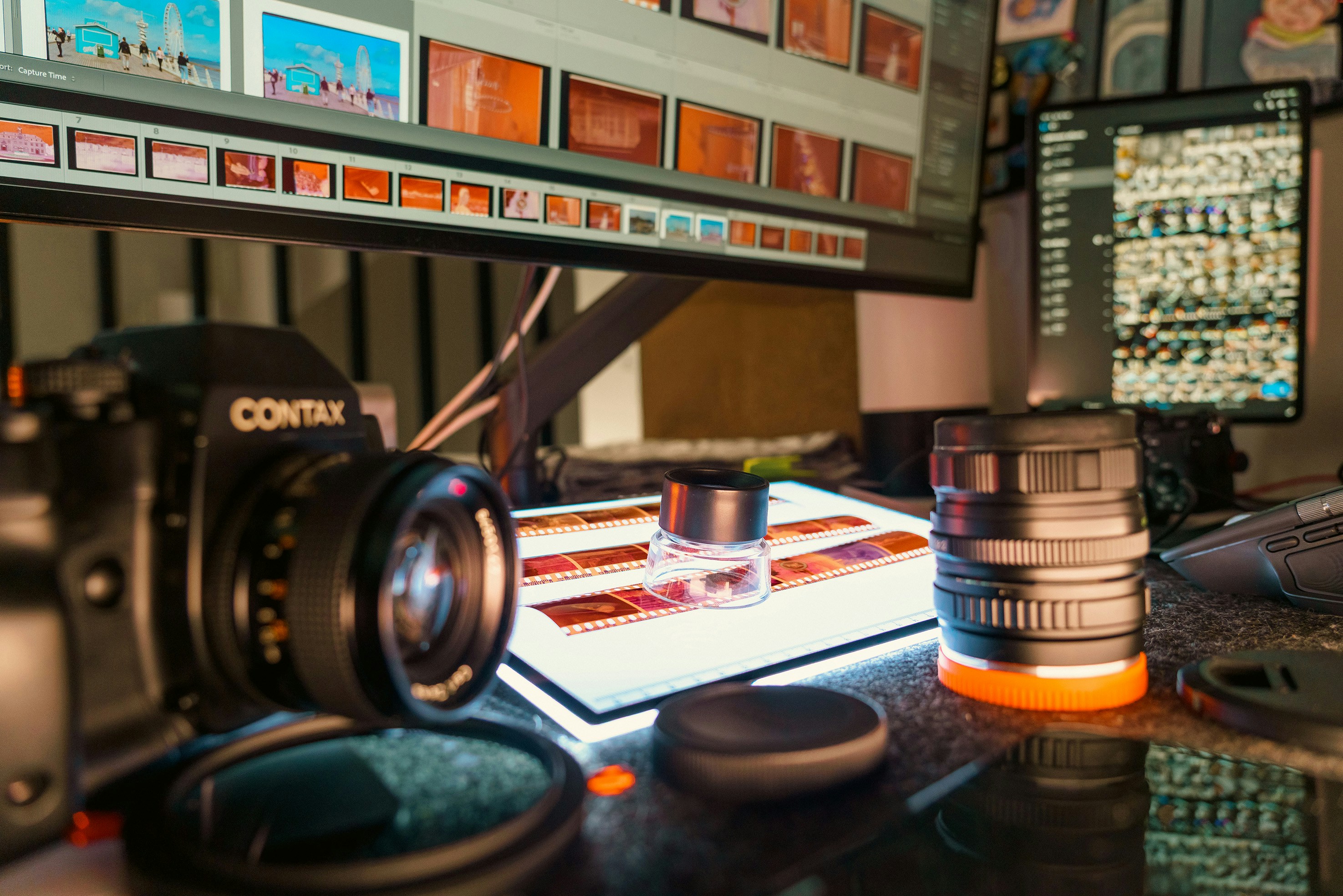 Camera, lenses, and light table with film strips.