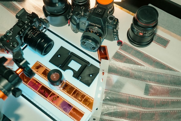 Film cameras and negatives laid out on a table
