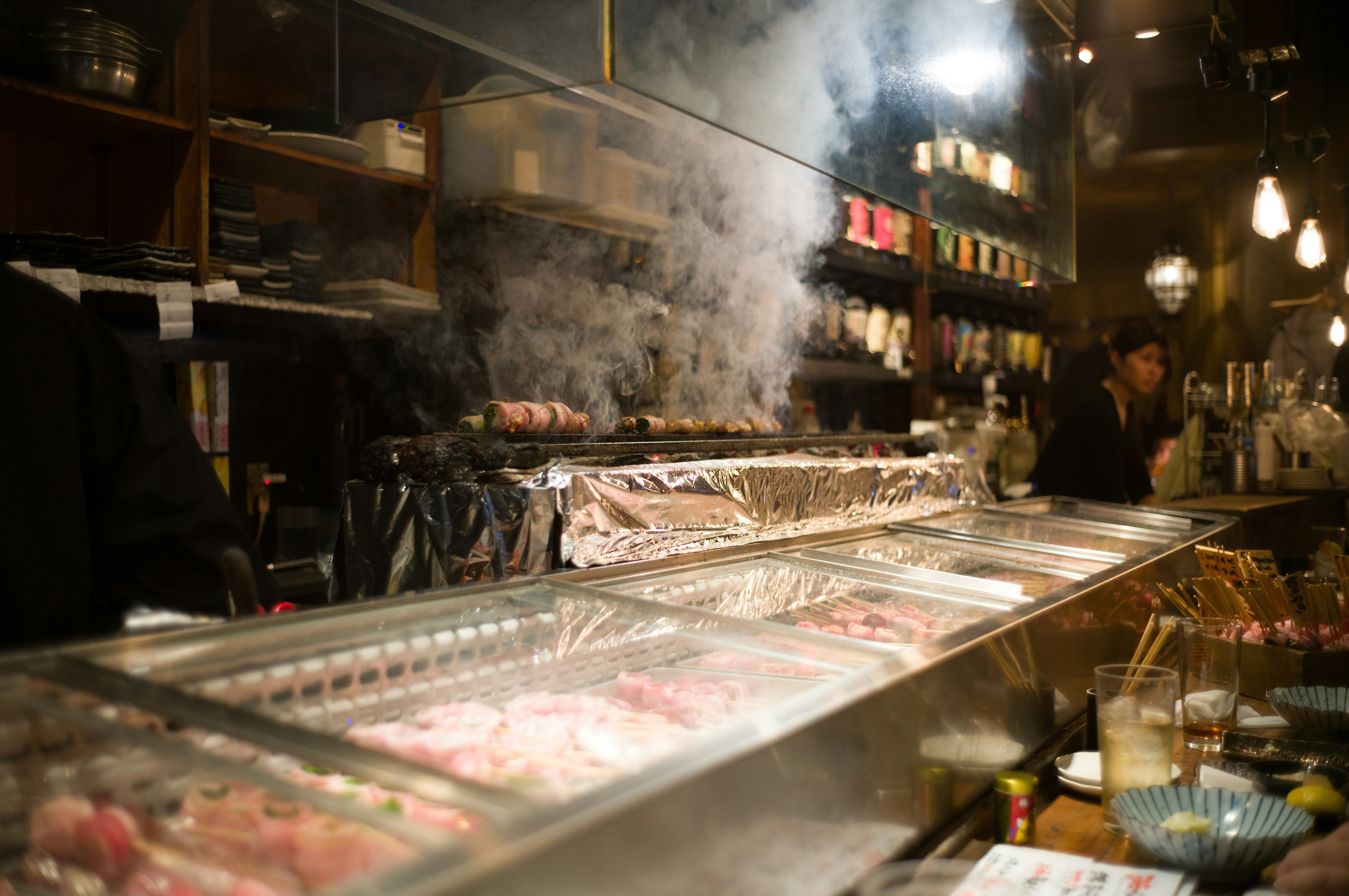 Chefs cooking food in a steamy restaurant kitchen