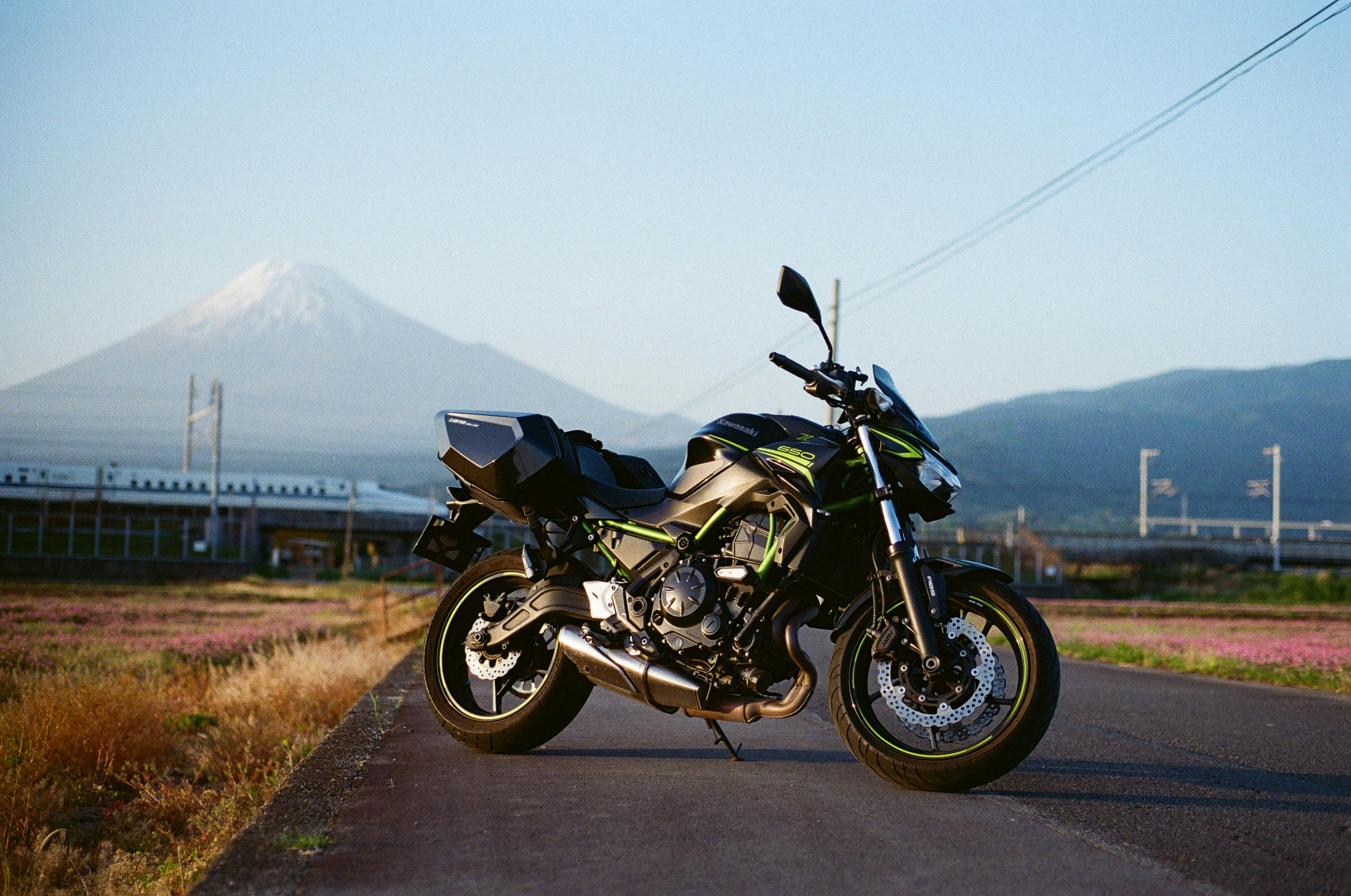 Motorcycle parked on road with mount fuji background