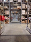 Warehouse storage aisles with shelves full of boxes