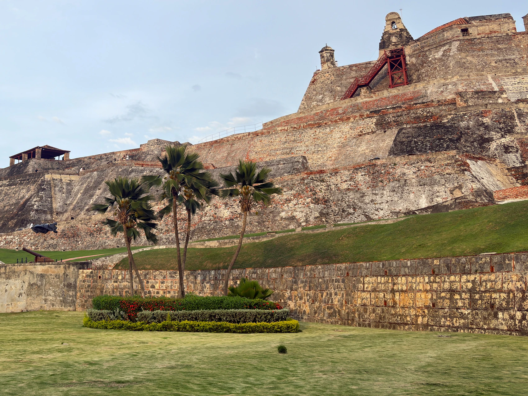 The immense stone ramparts of Castillo San Felipe de Barajas above lawns and palms