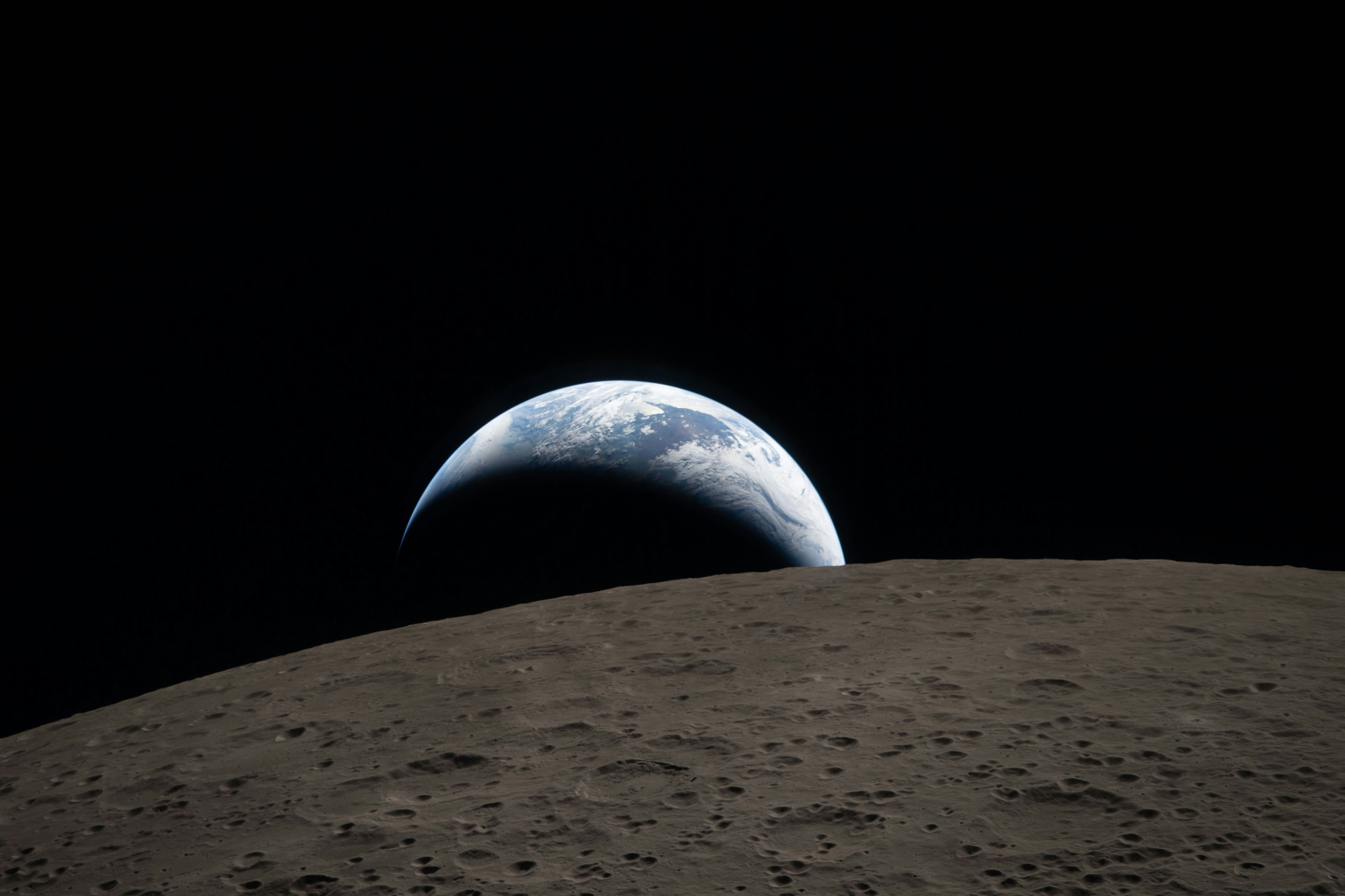 Earth rising over the moon's surface