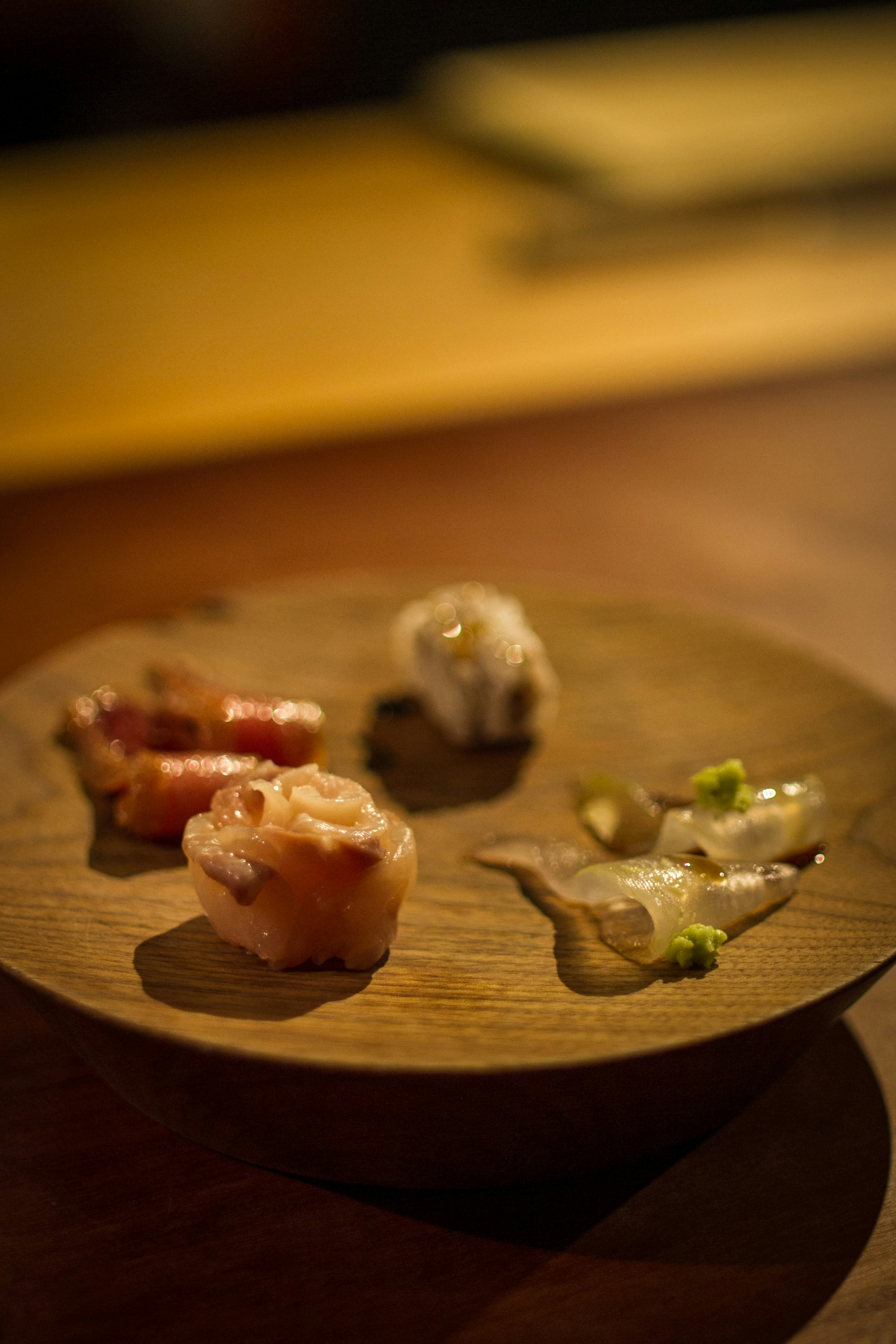 Small pieces of sushi on a wooden plate