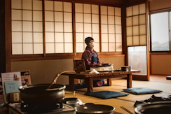 Man preparing food in a traditional japanese room.