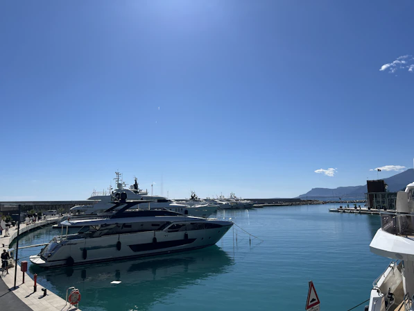 Luxury yachts docked in a clear blue harbor