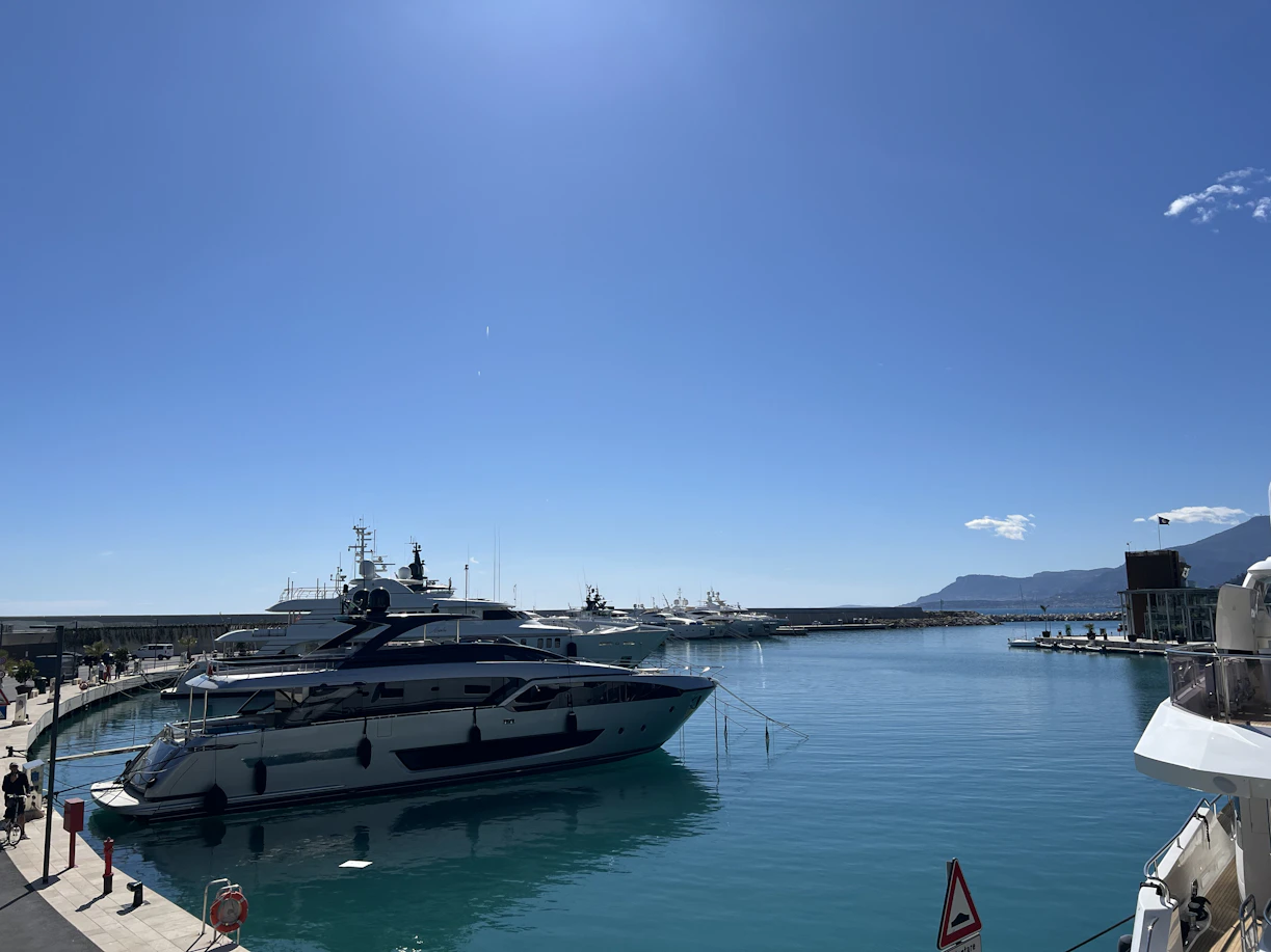 Luxury yachts docked in a clear blue harbor