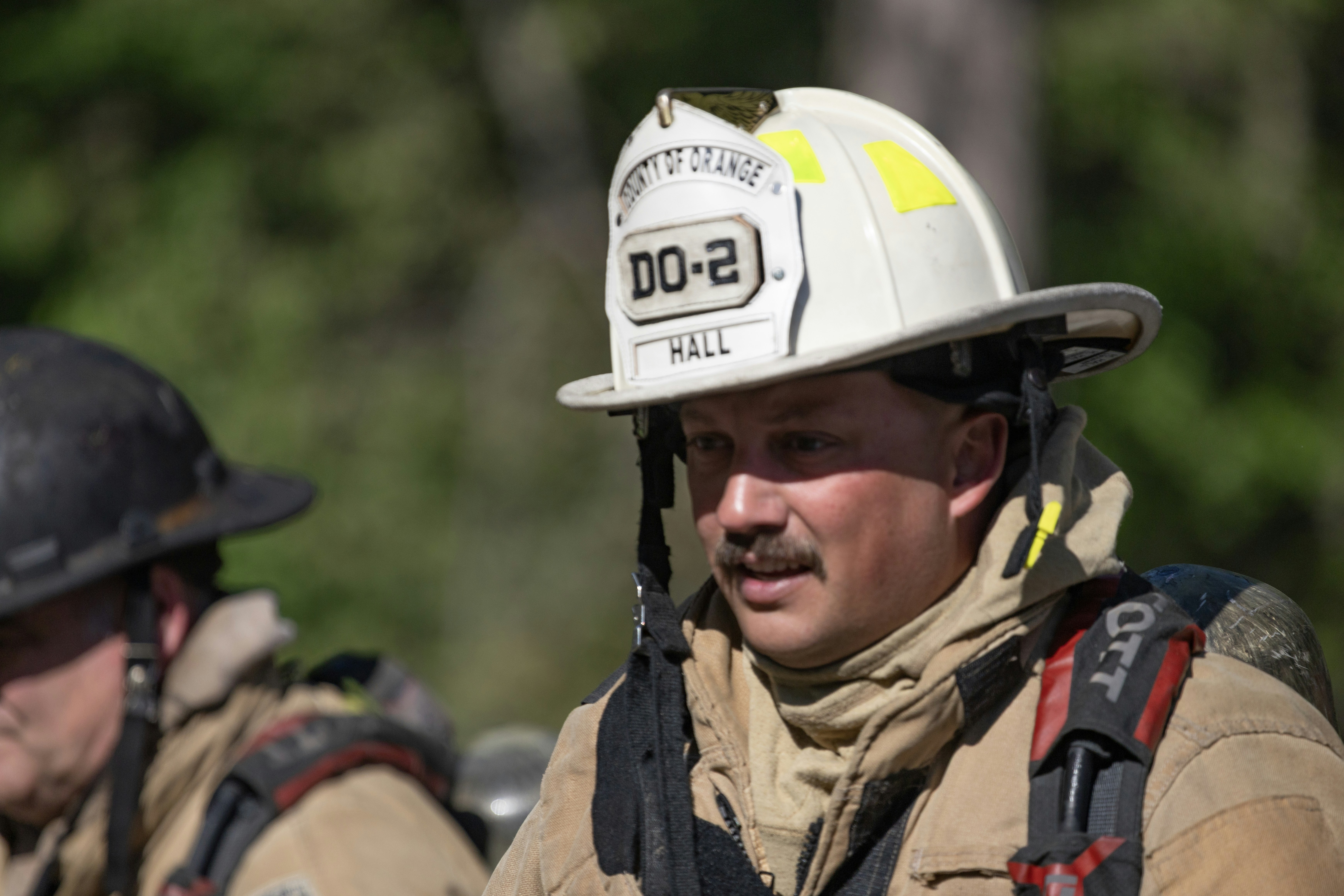 An emergency responder in a helmet at the scene